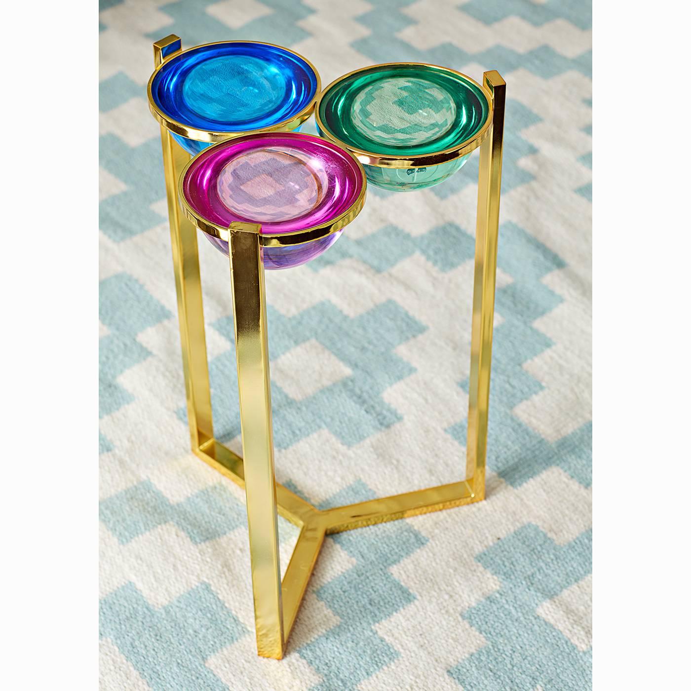 Futuristic elegance. A cocktail table as chic as your cocktail jewelry. A polished brass frame cradles cabochons of candy colored Lucite for a drinks table with dimension. Each Lucite half-sphere is set into a ring of brass. The mind-bendingly
