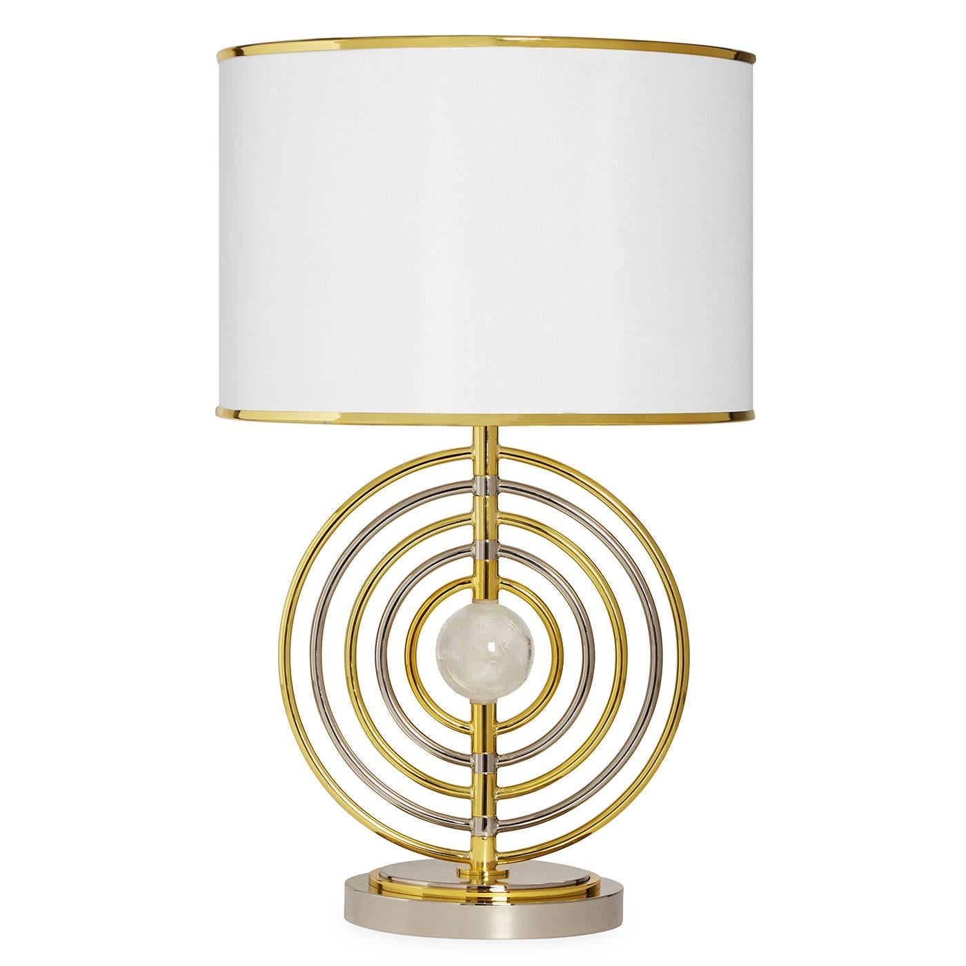 Mixed metals. A quartz crystal sphere surrounded by Space Age-inspired rings of polished brass and nickel and topped with a polished brass trimmed shade. The semi-precious stone adds a touch of twinkle, while the movable rings offer endless
