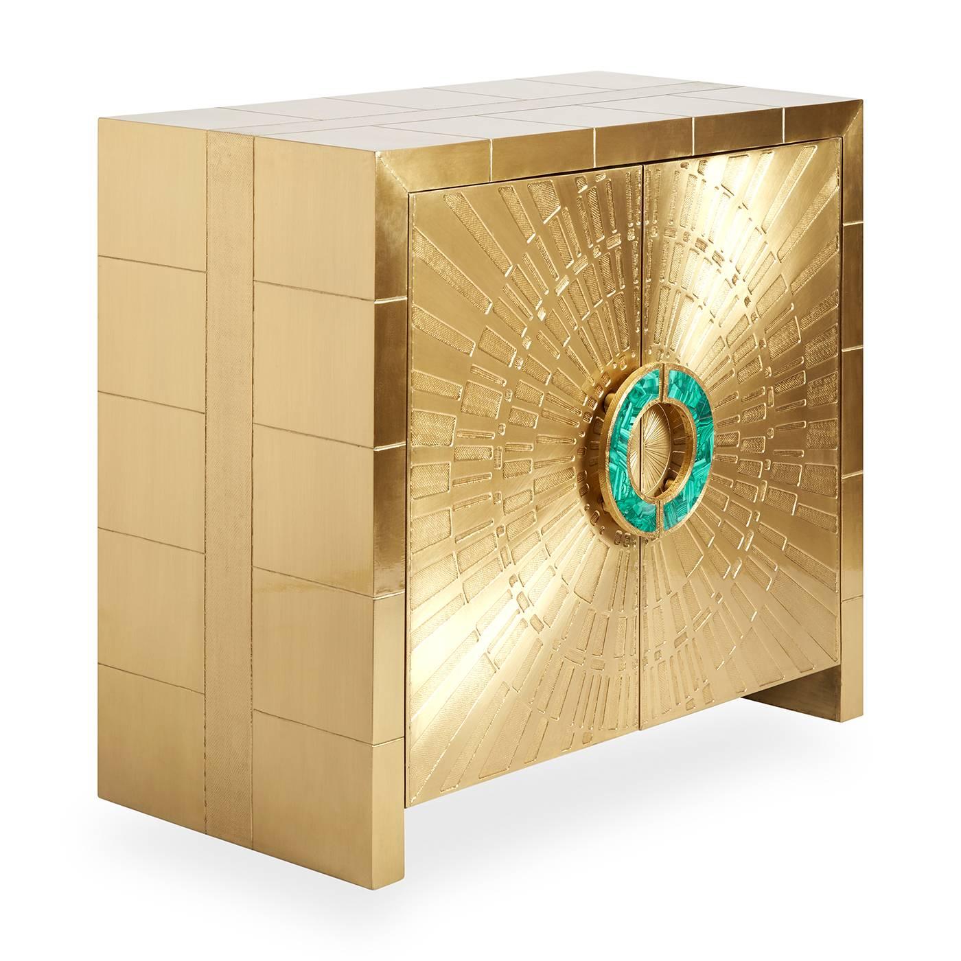 Global glamour. Our beloved Talitha cabinet gets a Midas and malachite makeover. Sheets of solid brass are hand-stamped into minimalist, modernist patterns routed onto solid wood. The surface radiates a lustrous and louche glow—but is wonderfully