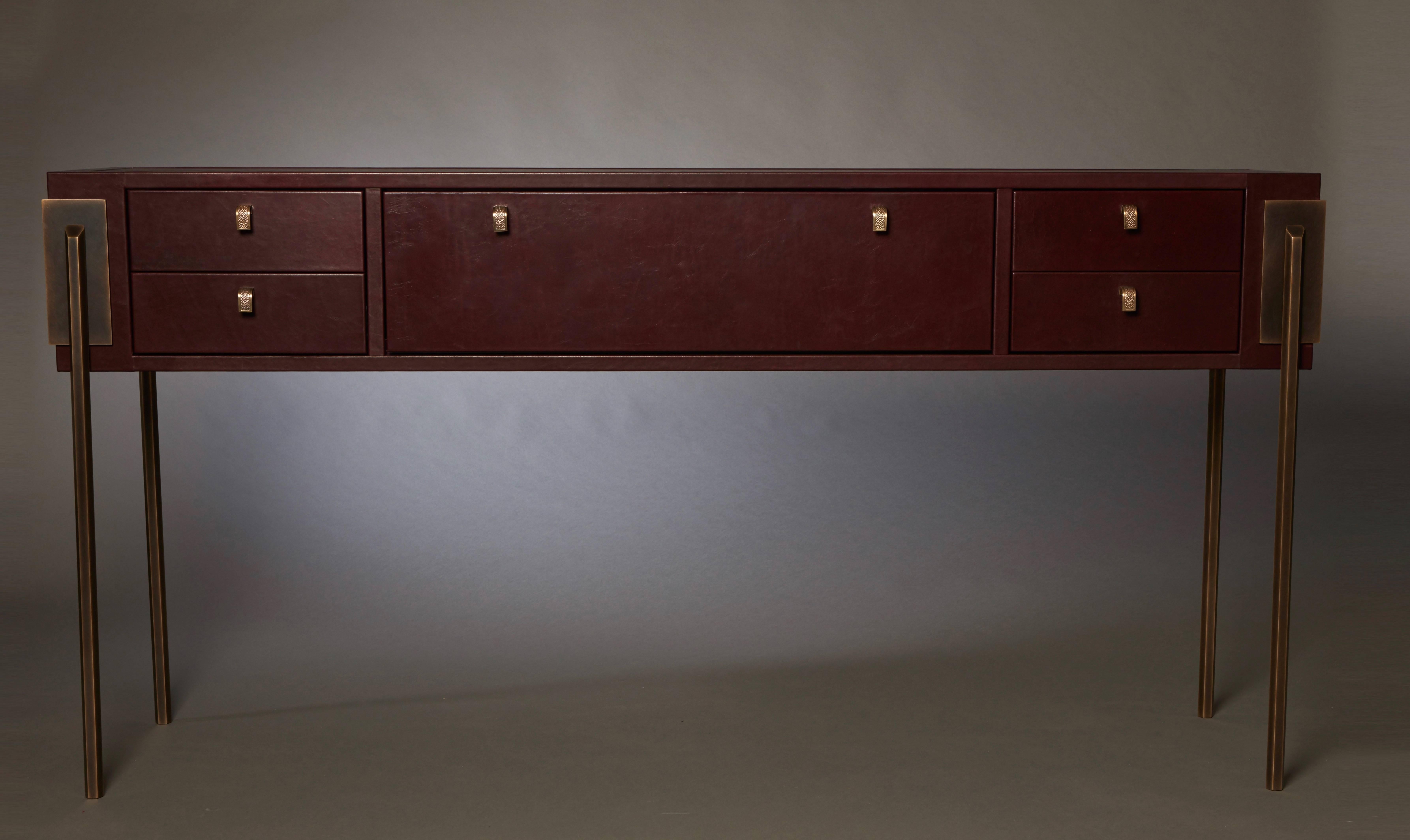 The 'Black Orchid' console draws inspiration from Art Deco architecture and features strong, yet elegant, proportions. The console is clad with a waxy aniline leather and is finished with shagreen cast bronze pulls. Its interior drawers are lined