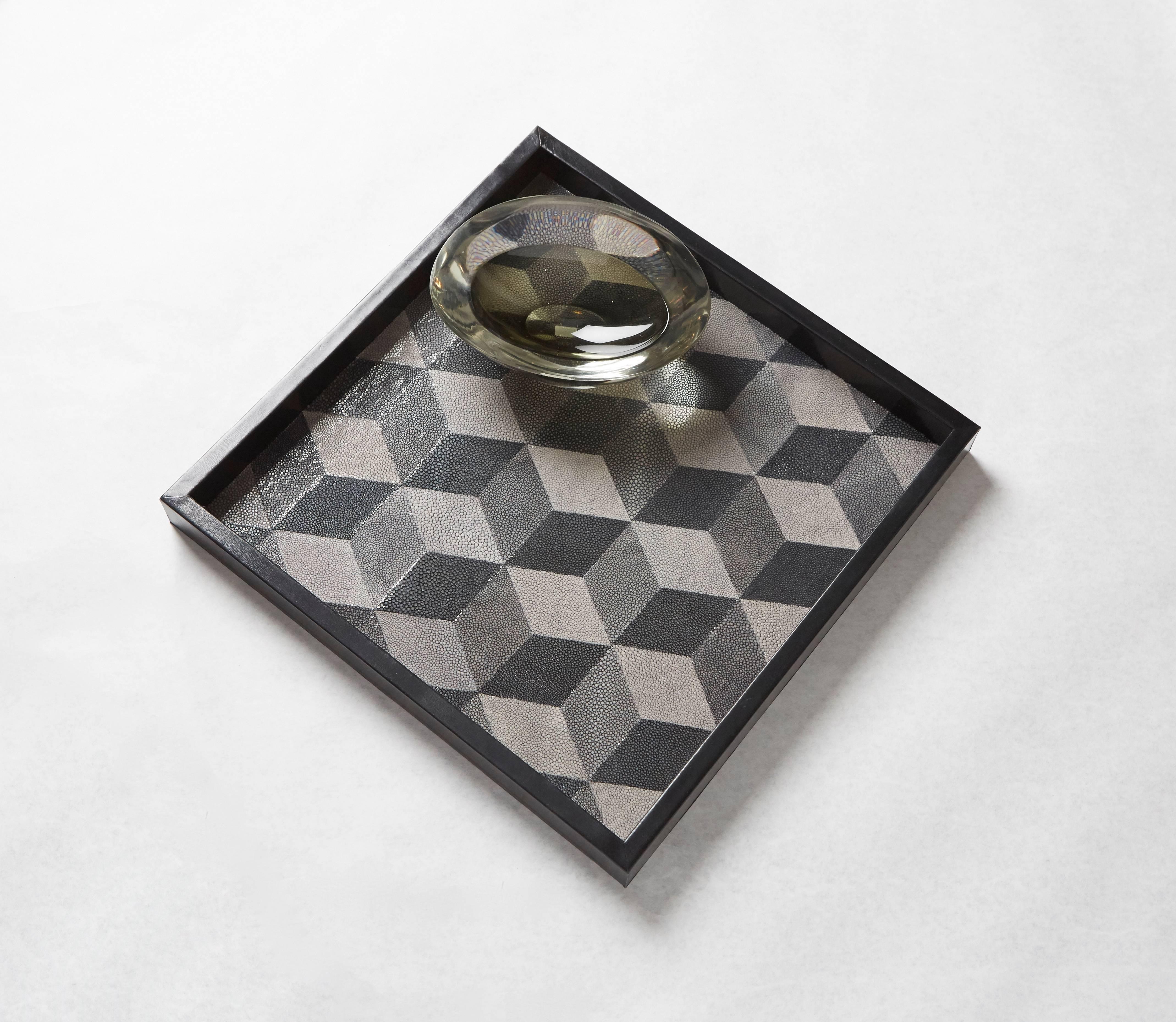 With an emphasis on textural and geometric elements, the Shagreen Geo tray is a masterpiece of symmetry and monochrome. Perfectly sized cubes in various gradients of gray appear to extend from the tray's surface with an Escher-esque quality of