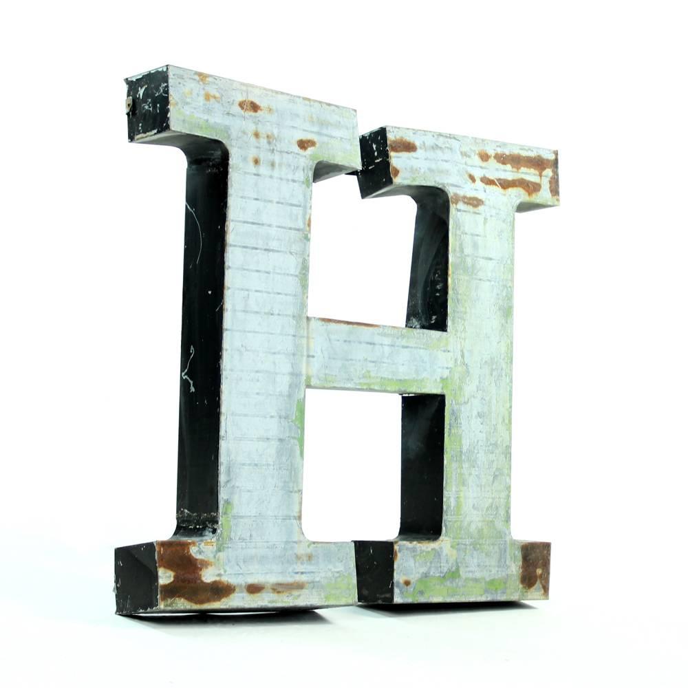 Rough and impressive, this metal letter was originally used in a factory in Czechoslovakia, now it is a statement of the past. Made of shaped metal sheet, it is empty from behind, therefore quite light to hang on a wall. The letter has little metal