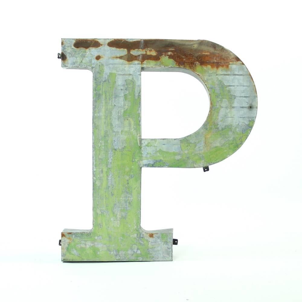 Pure Industrial design for any modern interior. This letter P comes with a history of being a part of the factory sign in Czechoslovakia. It is made of shaped sheet metal. The letter is in an original condition with rust showing, some history green