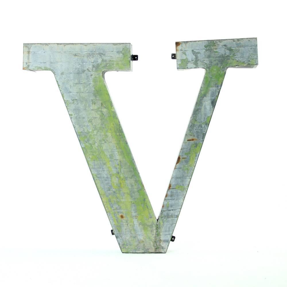 Beautiful, yet rough. This V letter sign is a pure Industrial item. It has a history as a part of the factory sign in Czechoslovakia. Made of shaped sheet metal, it is empty from inside, so light to hang on the wall. Fixtures which are originally