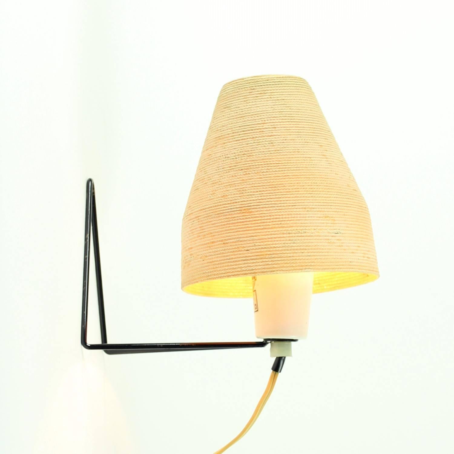 This rare Industrial lamp is a part of a long and unique tradition. It was produced by Pokrok company in Czechoslovakia. Its design is quite simple, yet very important. The lamp was one of the first models which used bended black metal wire as a