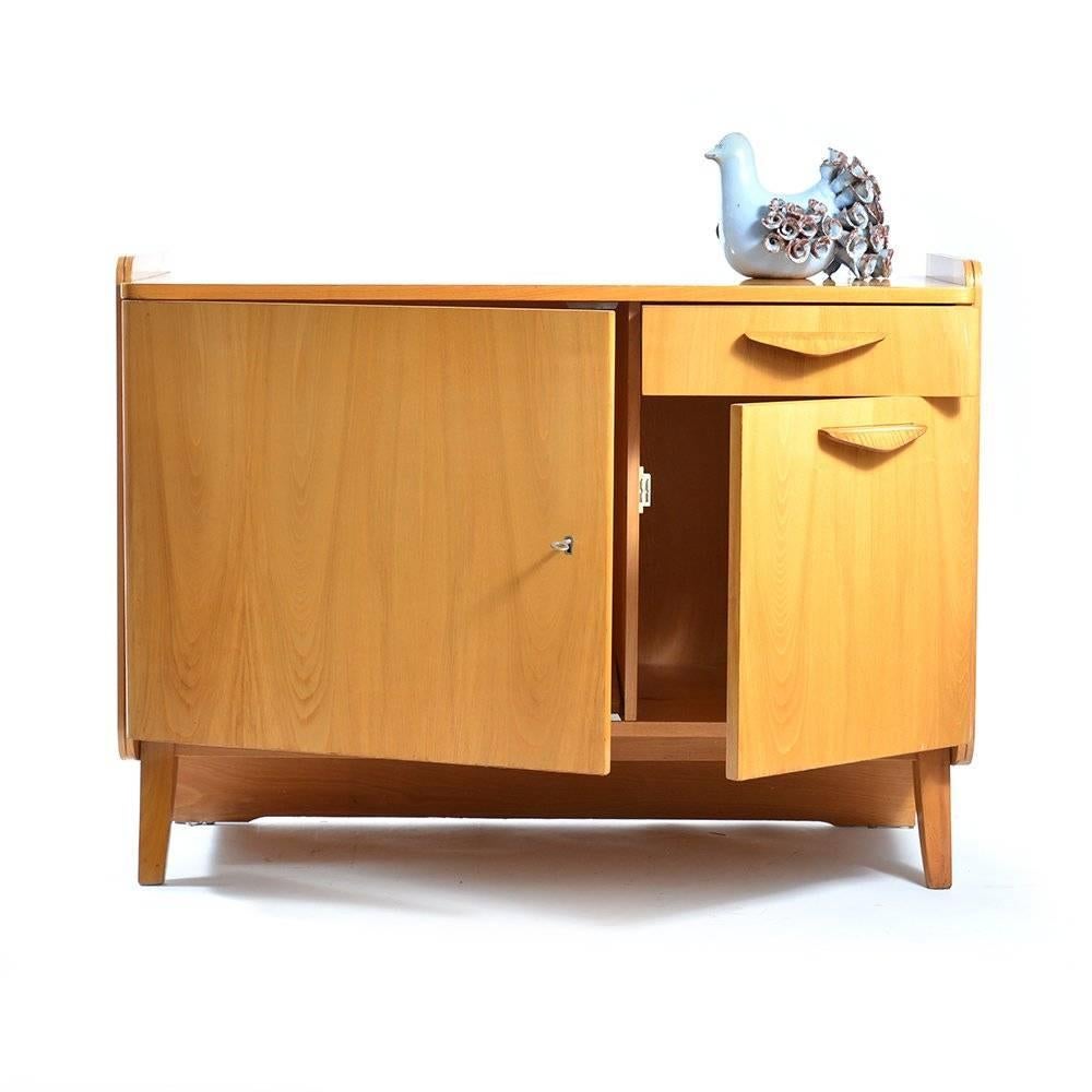 This elegant sideboard combines the mid-century design with the vintage Czechoslovakian feel of the past. It was created by Tatra Nabytok, the National Furniture Company in deep Czechoslovakian regime. Yet it still kept the original charm. Made of