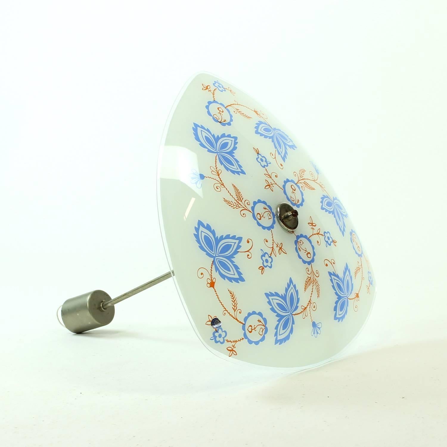 Elegant and beautiful ceiling light, so very typical for the midcentury design period. Created by Napako company in 1960s. The glass plate is decorated with folk pattern. The construction is aluminum. Very good condition with minimal wear visible