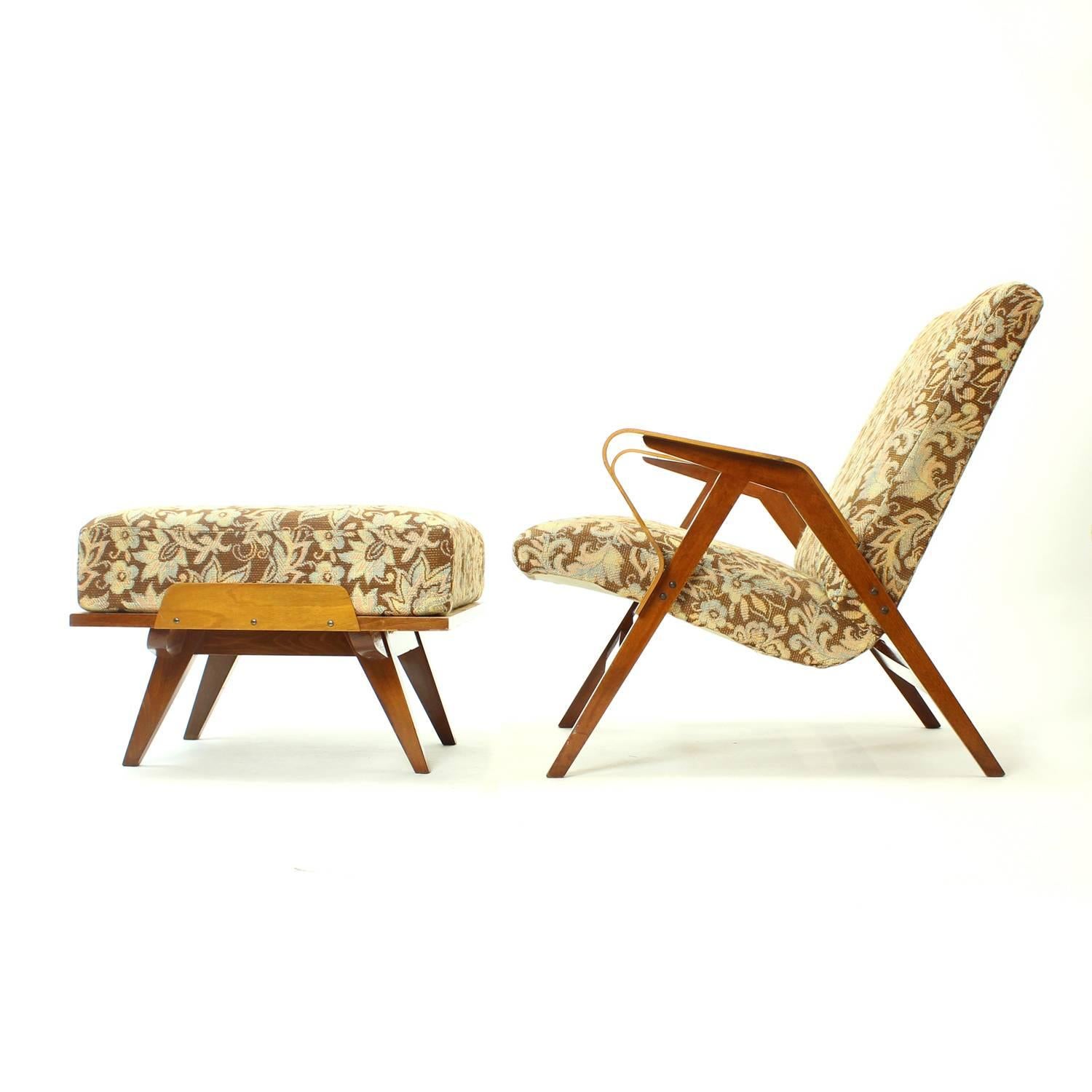 Typical midcentury design of the armchair produced by Tatra. A rare set with an original ottoman, which is big enough to be used as a sidetable or an extra chair. The wooden construction of the chair and ottoman shows some typical features of the