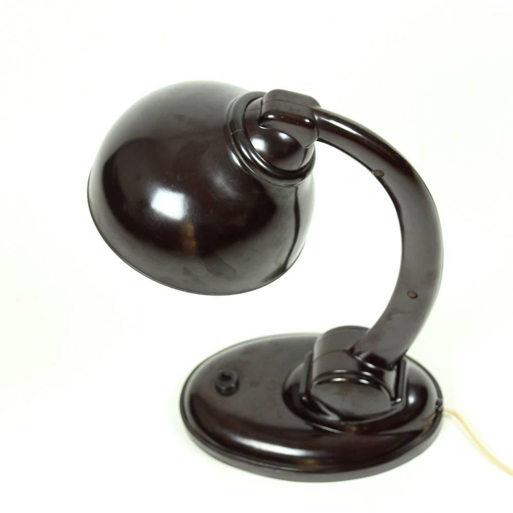 This bakelite lamp, model 11126, was designed by Eric Kirkham Cole and was produced by EKCO Ltd mainly in the 1930s. In the 1930s it was licensed to be produced in Czechoslovakia. The lamp ismade of dark brown bakelite, very durable and stylish. It