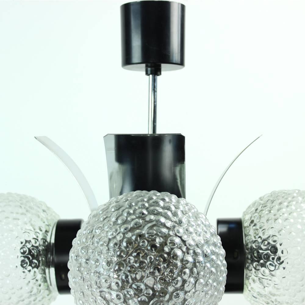 This unique ceiling light might be from 1970s but its style is still very modern today. Chrome construction and bended chrome plates make it a masterpiece in any room. Five glass balls cover the bulbs and soften the light. Excellent condition,