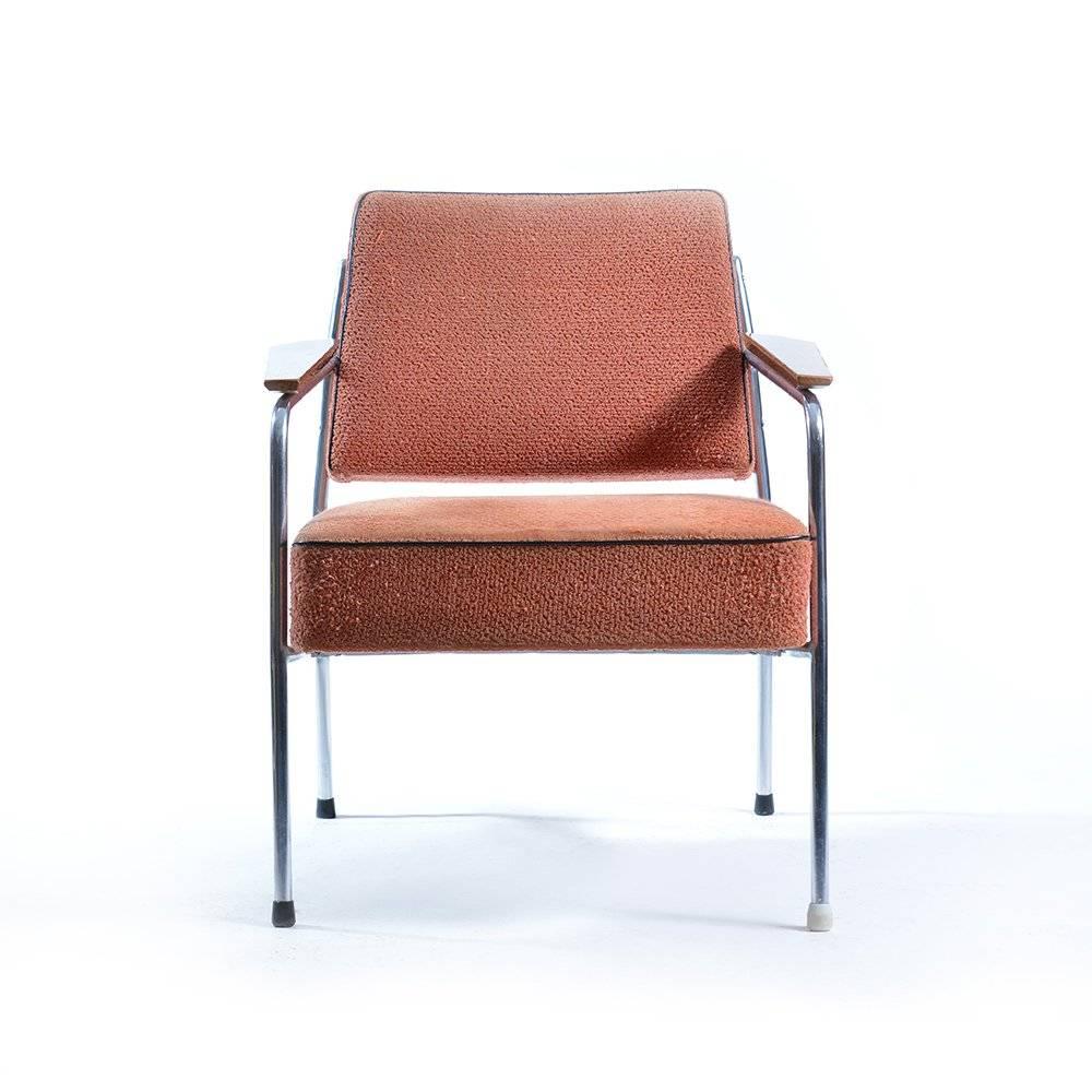 Typical Brussel style armchair made in Czechoslovakia in the 1960s. Metal construction with chrome finish, dark wooden armrests and stylish faded pink color. Some wear visible on upholstery. Chrome and wood in excellent condition.