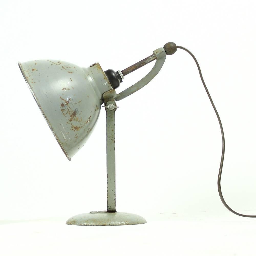 Gray industrial table lamp BAG Turgi, made in Switzerland in 1930s. Apparent signs of use and time has only made this item more beautiful. Interesting feature is an adjustable bulb holder by which you can set your own light intensity. Fully