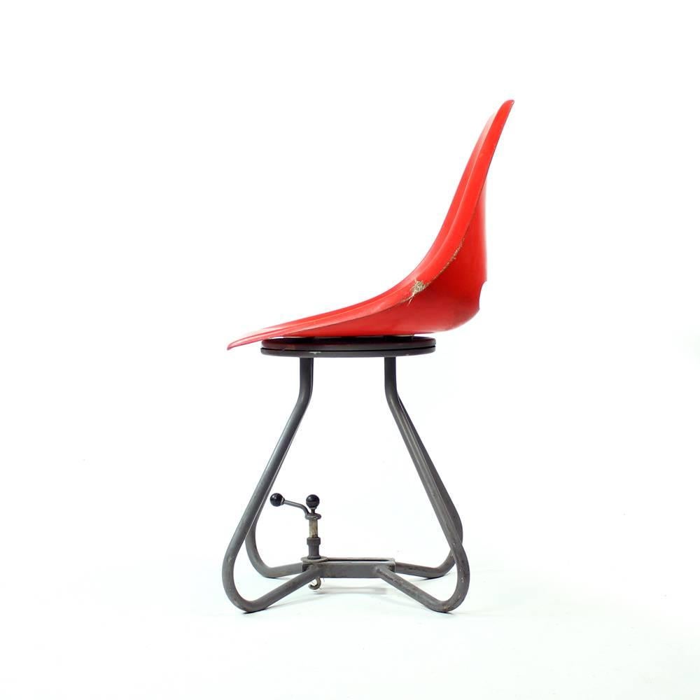 Original midcentury chairs in red fiberglass seat. Designed by Miroslav Navratil for Vertex company. This seat model was used in Czechoslovakian trams. Industrial model with lots of character. The red fiberglass seat sits on metal base. The handle