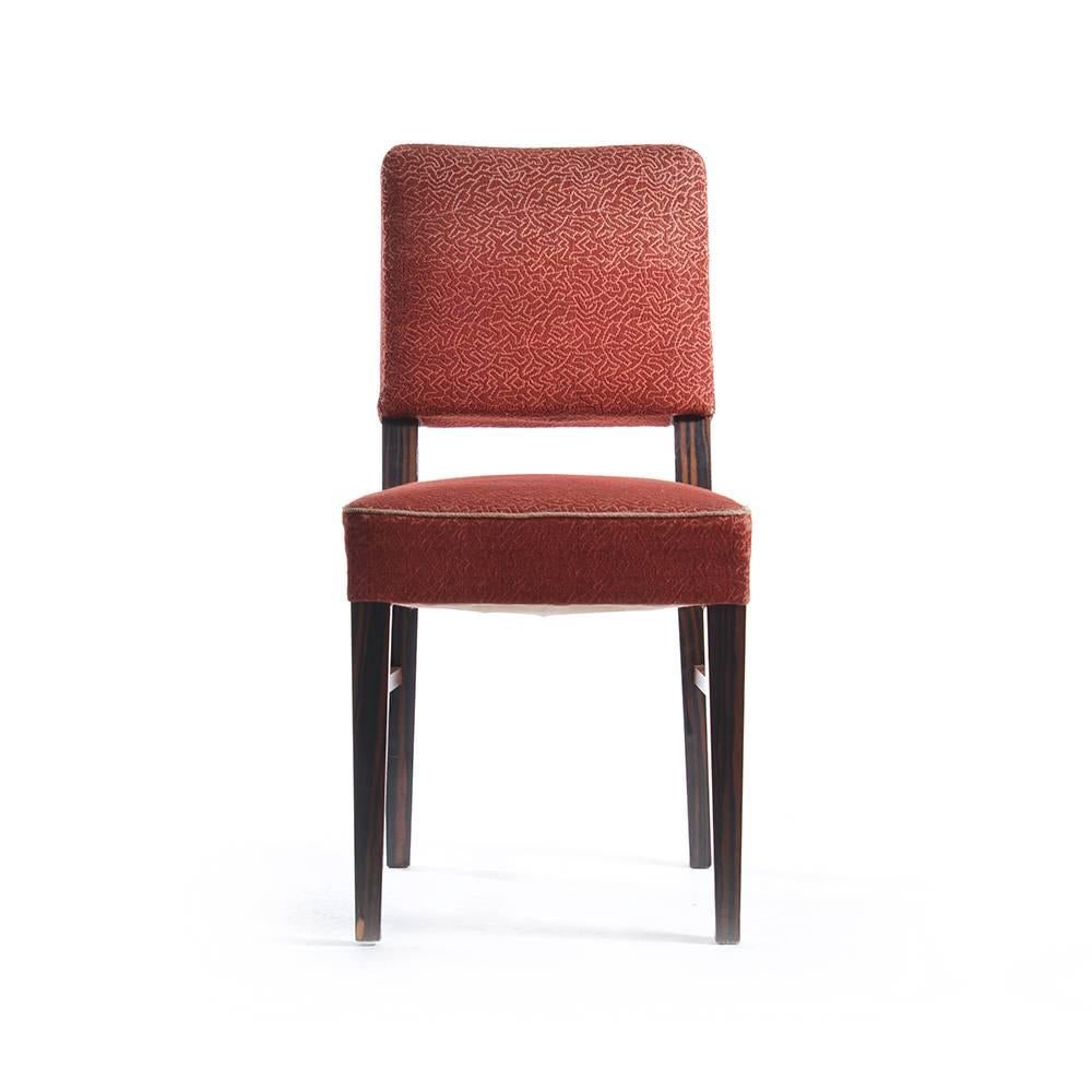 Elegant set of four dining chairs made in Czechoslovakia in 1940s. The design is very original. Chairs have an upholstered seat and backrest. The fabric is original, shows some wear, but still looks quite elegant. The wood is veneered into a