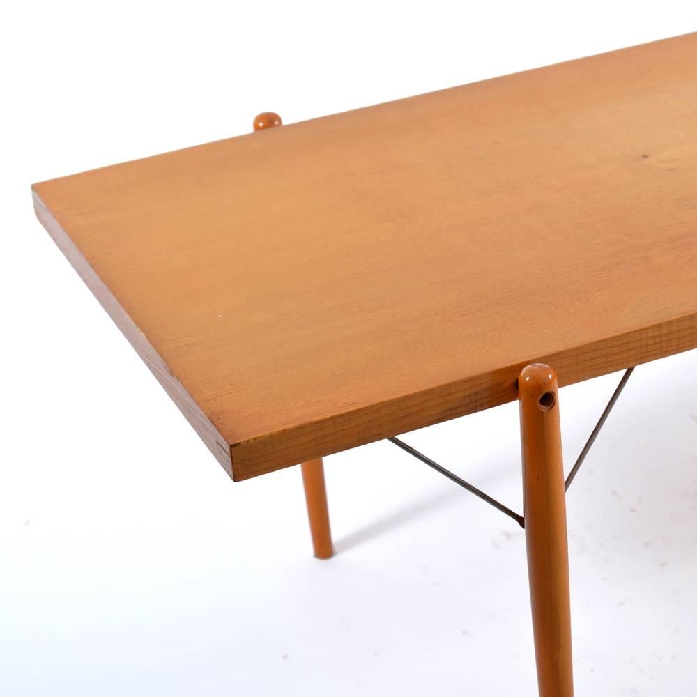 Long and beautiful wooden coffee table with interesting details of metal leg supports. Very good condition with only minor wear. Strong and elegant item produced by Jitona, Czechoslovakia in 1960s.