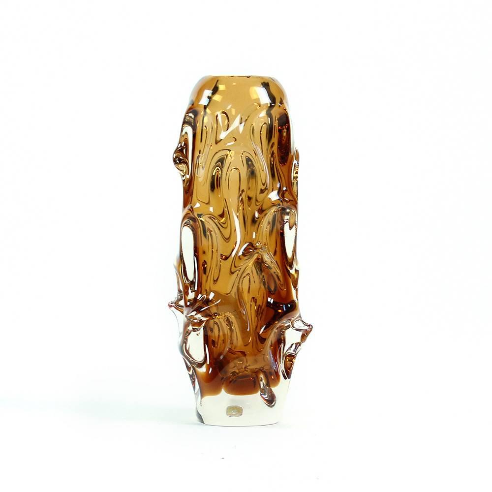Iconic work of Czech glass makers. Design by Jan Beranek in 1959 for Glass factory Škrdlovice. The vase is handmade of metallurgical glass with typical organic shape in amber and clear glass color. Heavy piece with little faded, but still present