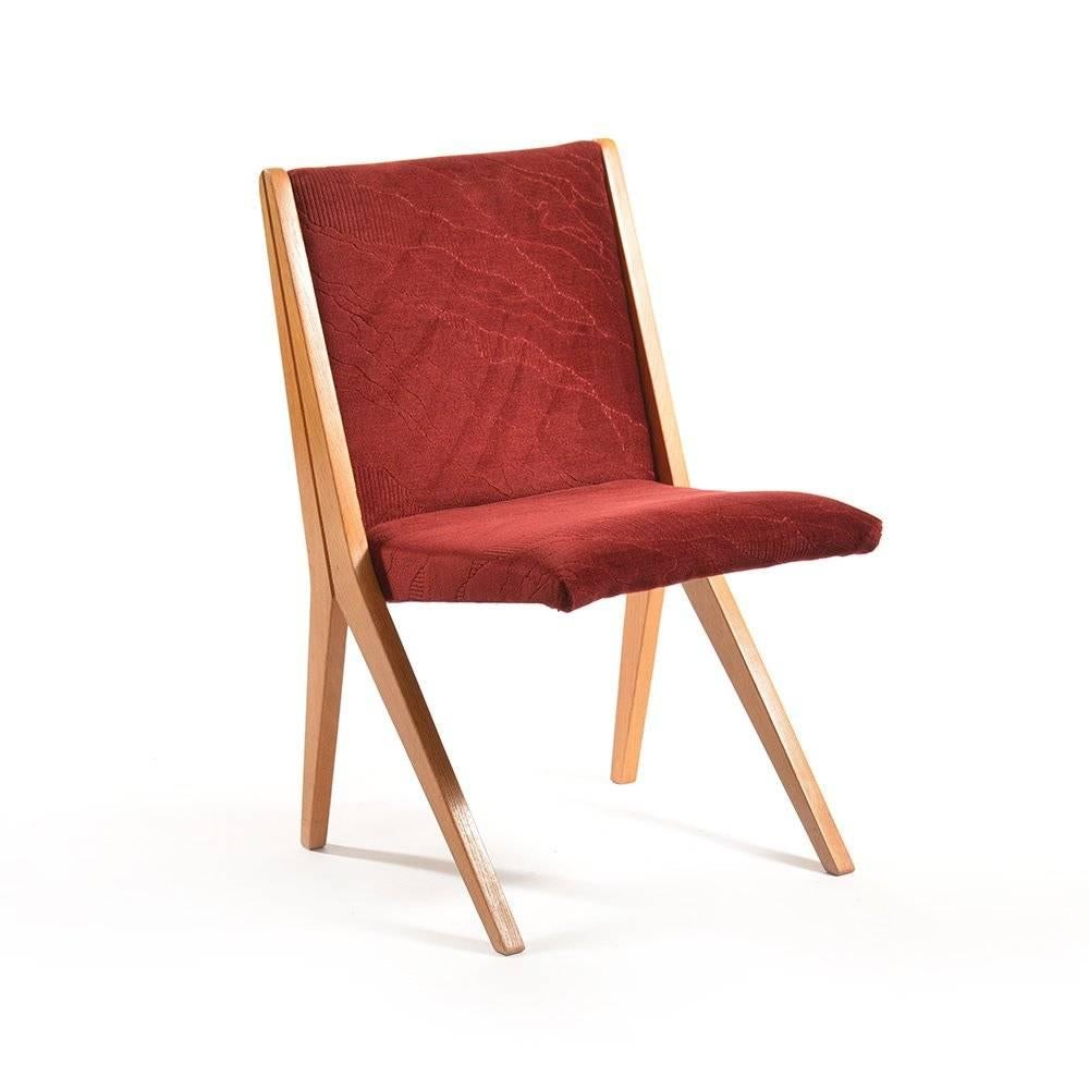 These are quite unique chairs of a very original design. They almost look unstable, but the great design makes these chairs wonderfully stabile without any risk. Very good condition with deep red velvet-like upholstery. Wood in very good condition.