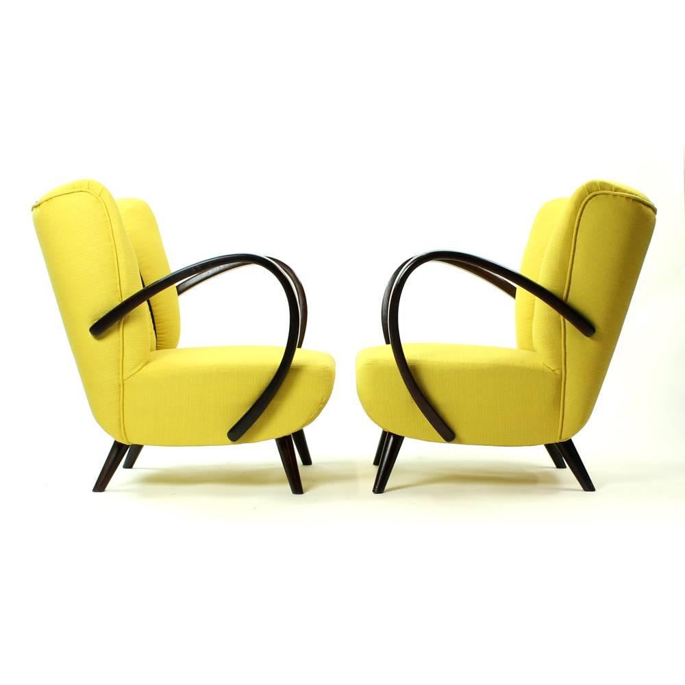 These beautiful armchairs by Jindrich Halabala are after complete restoration. New upholstery in fresh yellow color with black details. Restored wood details. Beautiful design chair with lots of details and unique style of bentwood so typical for