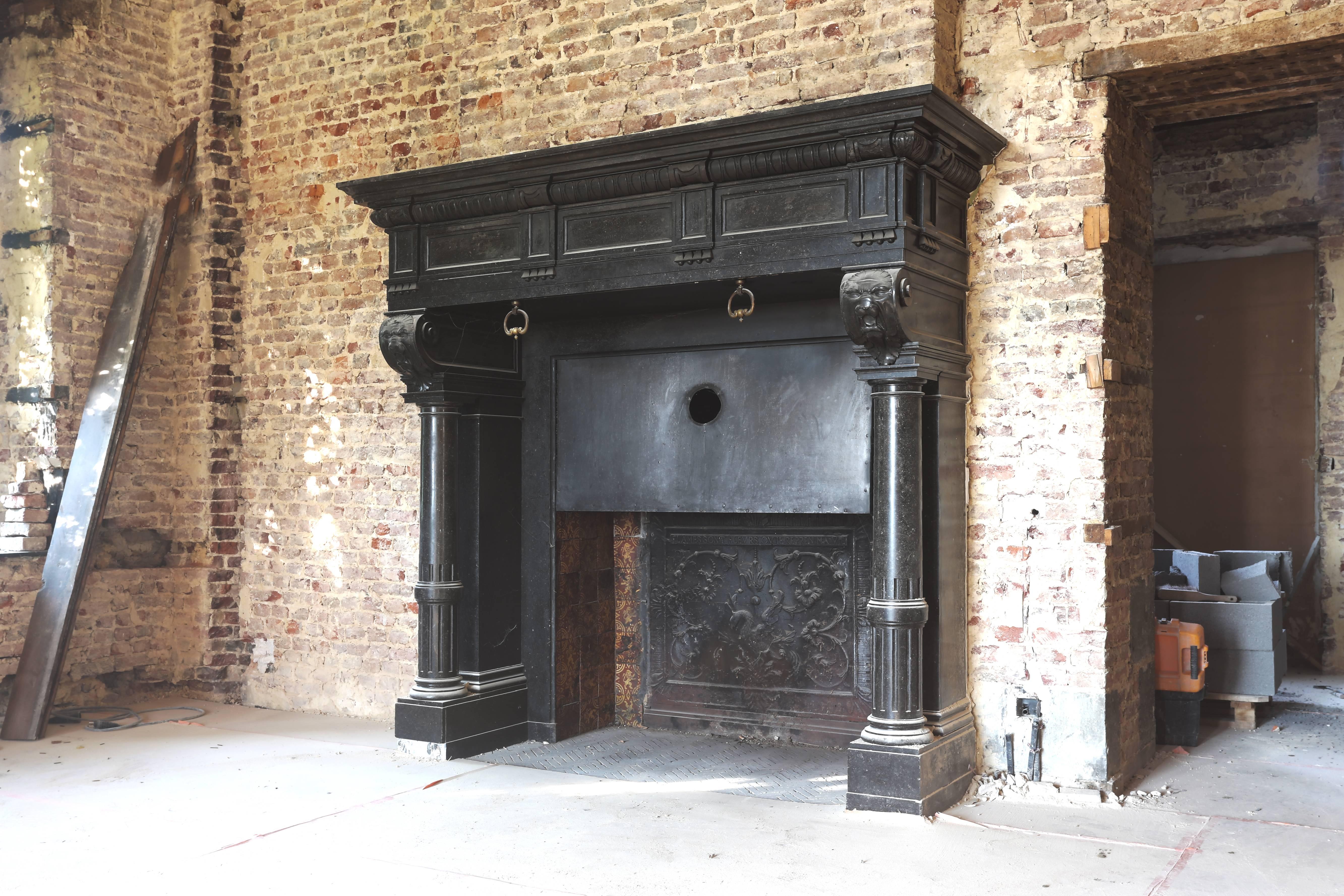 A very unique and exclusive castle fireplace of black marble. The provenance of this antique fireplace is Chateau de Doyon in the neighborhood of Namen (Belgium). This castle is built in 1892. The font part of the fireplace is nicely decorated with