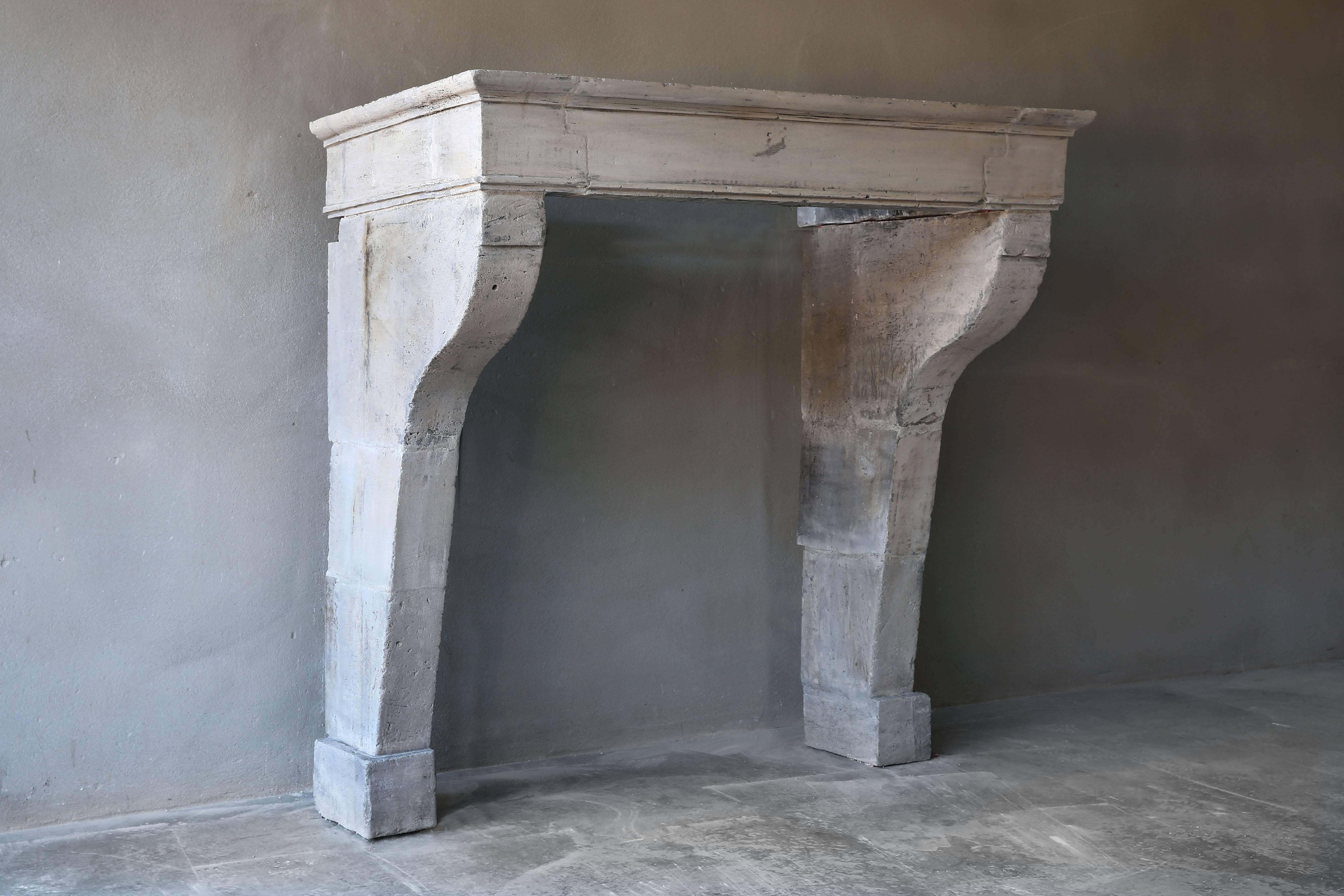 A very nice and sober antique fireplace of French limestone from the 19th century in the Campagnarde style. Formerly everyone who lived in a farm had such an antique fireplace to keep warm! They are still an eyecatcher in every interior!