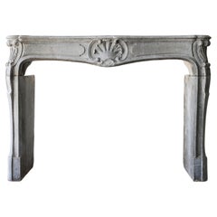 Antique fireplace of grey marble stone from the 19th century, style of Louis XV