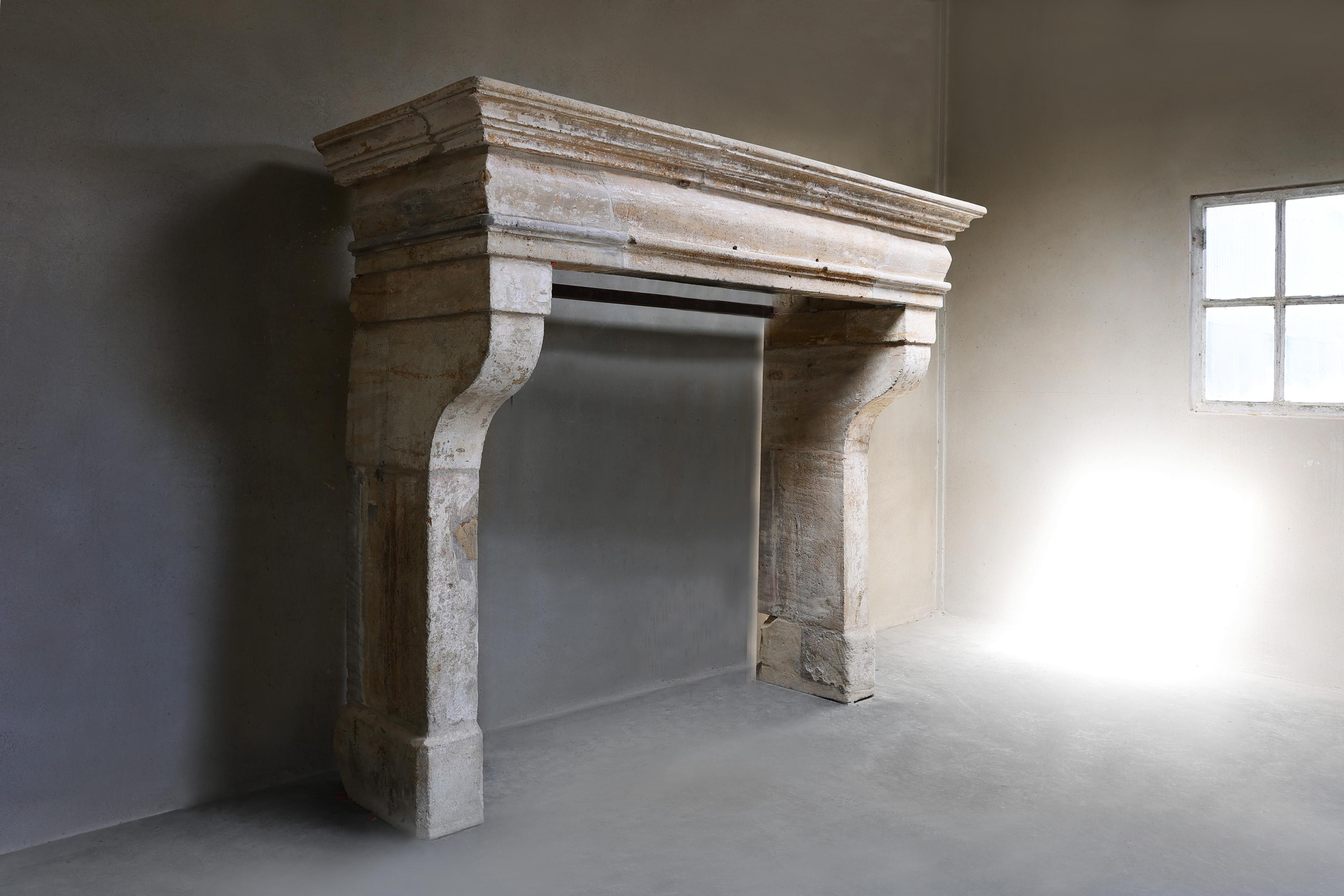 This 19th century French Campagnarde style fireplace is made from authentic limestone. The robust design and soft weathering give a warm, rural look. A timeless and characterful piece that adds atmosphere and charm to any room. Perfect for lovers of