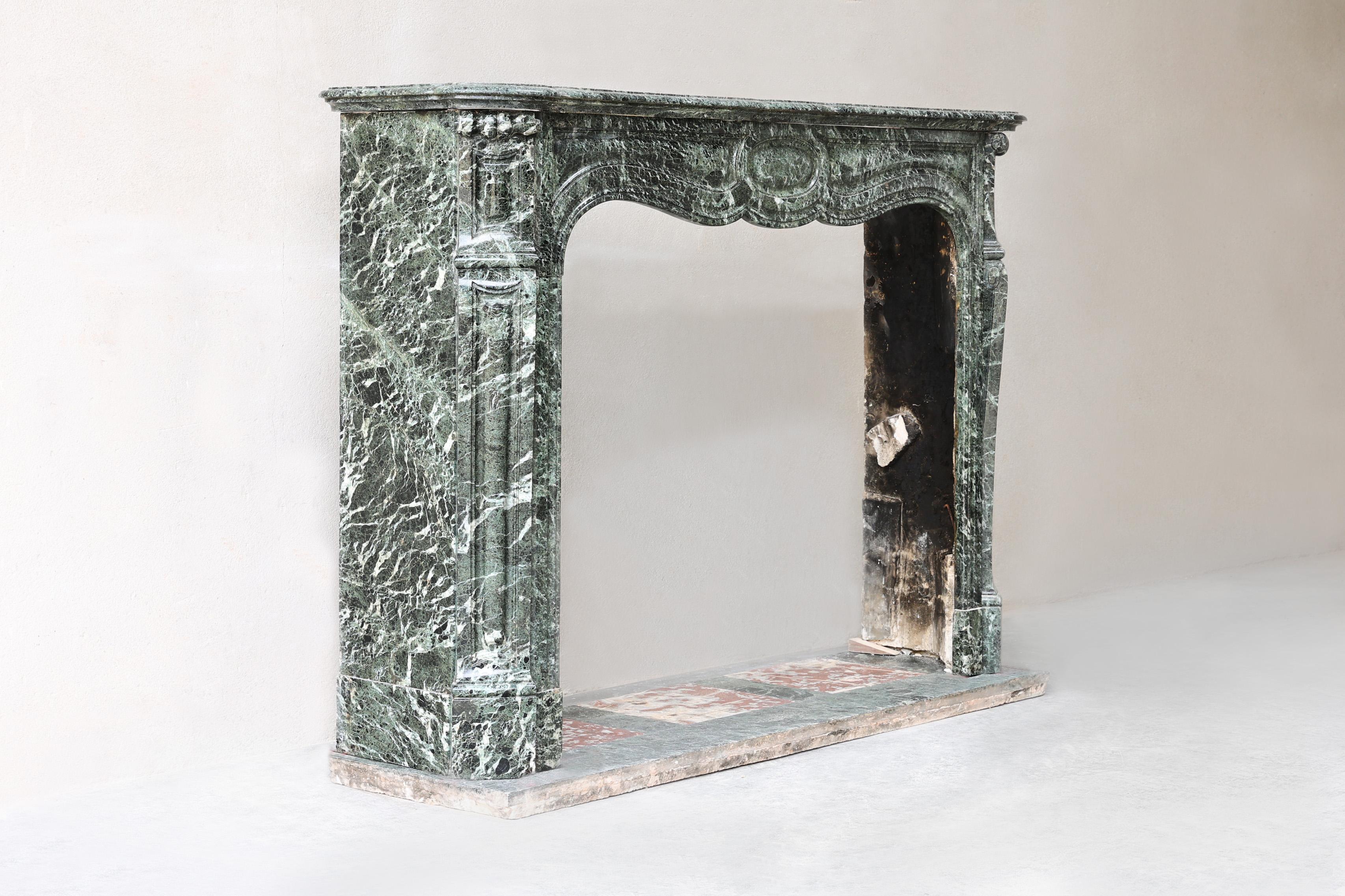 Discover this rare antique marble fireplace from the 19th century, made of exclusive Vert de Mer marble in elegant Pompadour style. With graceful lines and classic craftsmanship, this is a refined showpiece for any interior. Ideal for lovers of