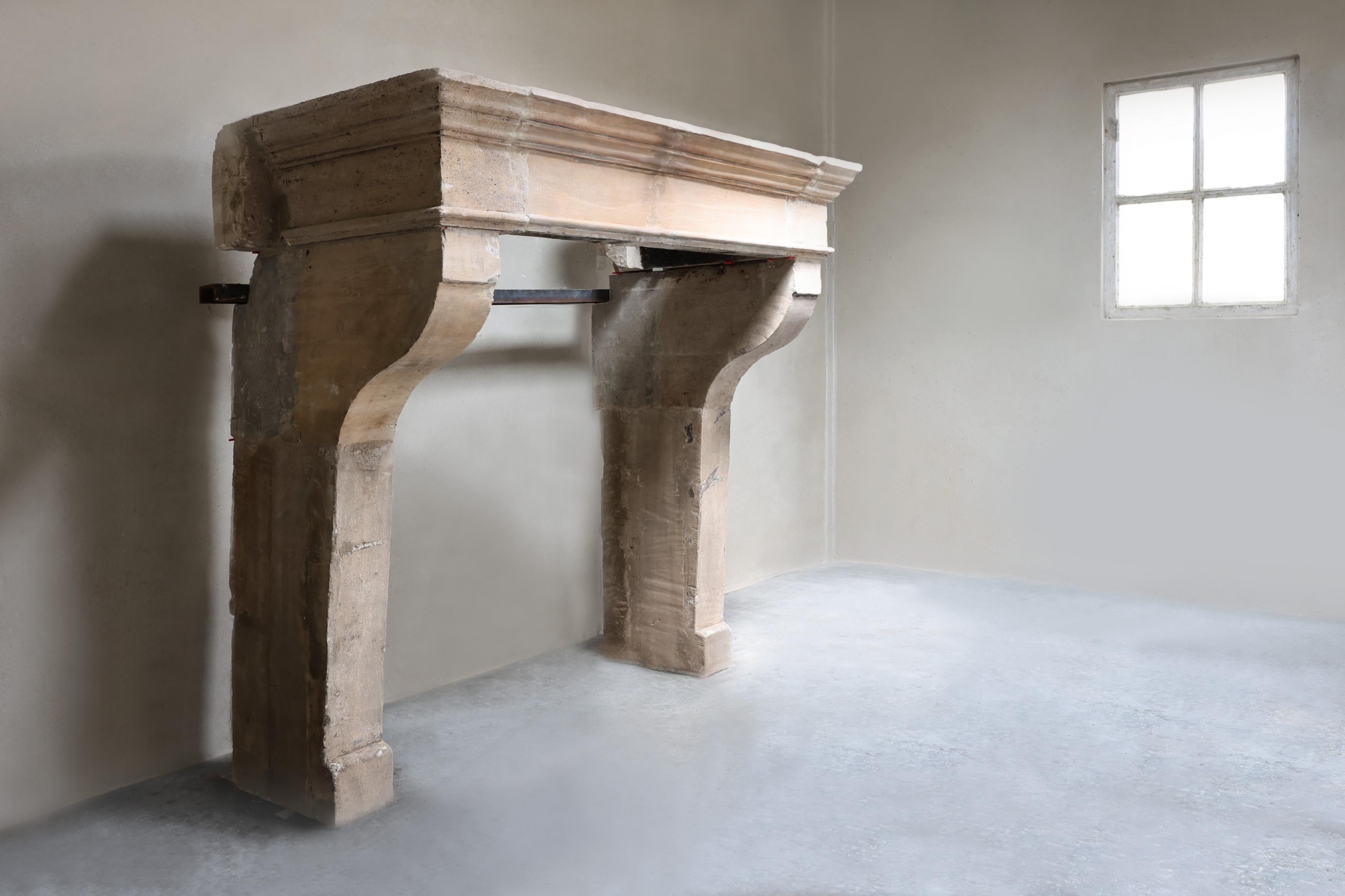 Beautiful antique French fireplace from the 19th century, made of authentic limestone. This robust fireplace in Campagnarde style immediately brings charm and character to any interior. A unique piece with a warm, rural look. The size of this