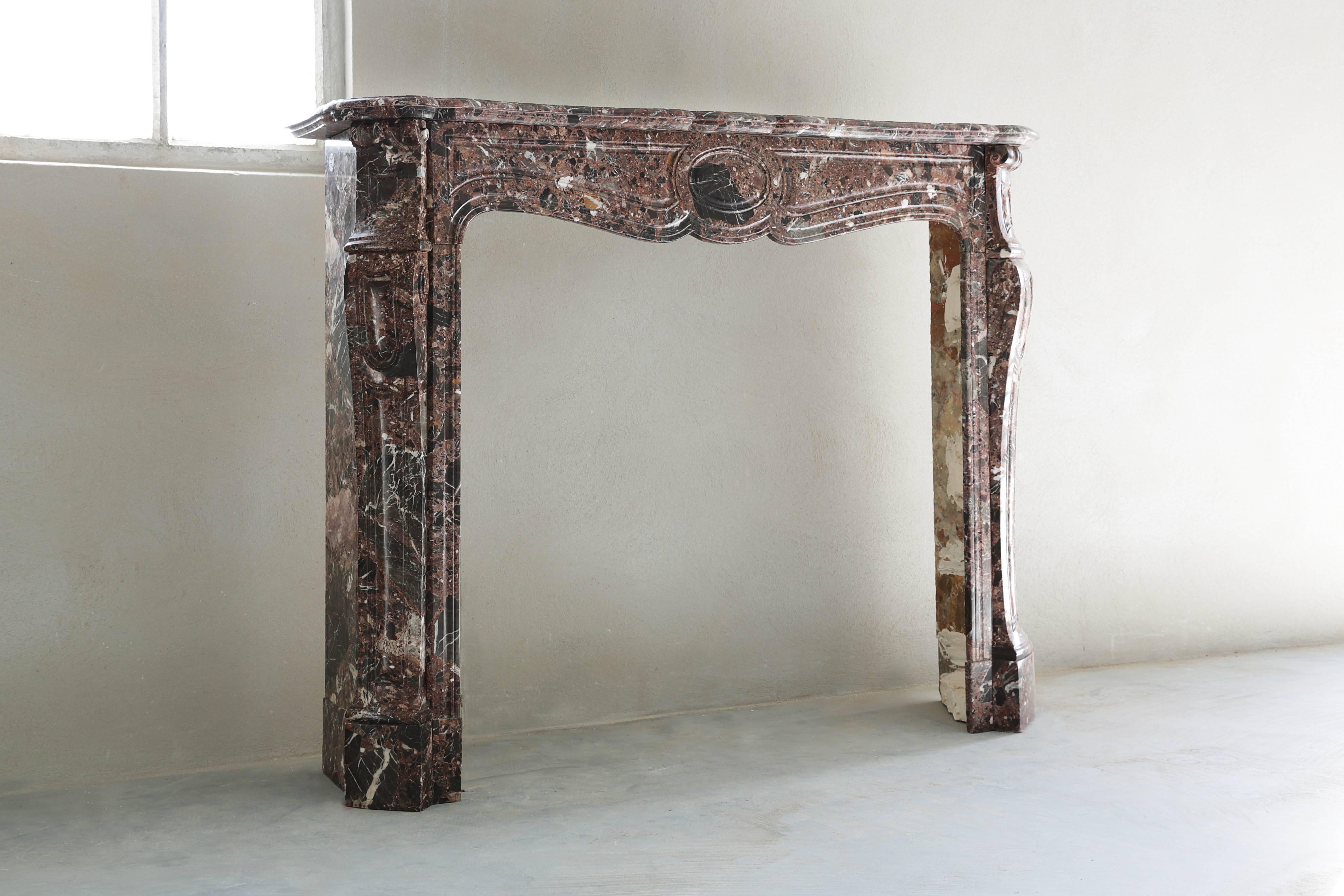 An elegant and nice marble fireplace in the style of Pompadour. We found this beautiful antique fireplace in Paris.