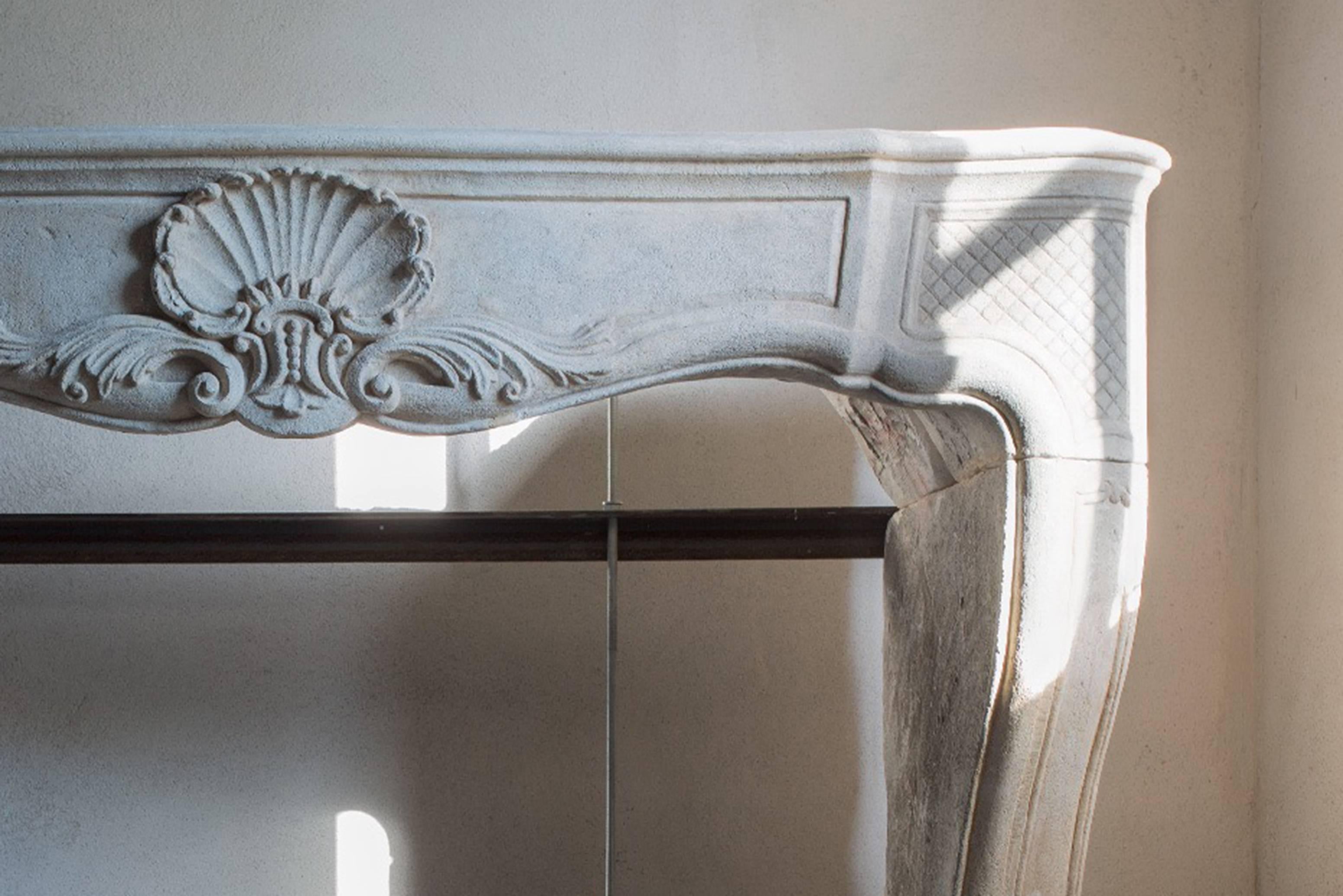 Very charming antique fireplace of limestone of the 19th century in the style of Louis XV.