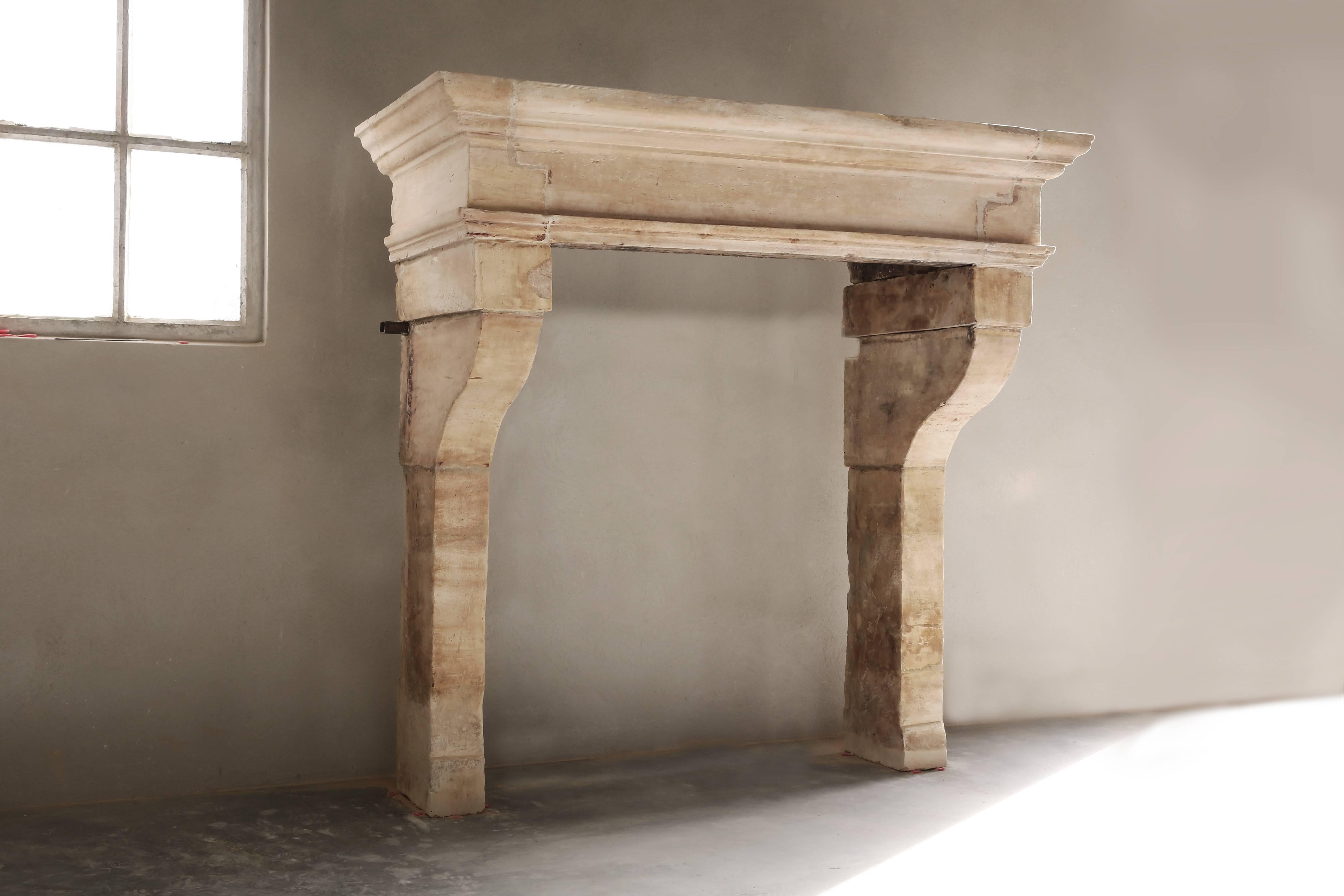 A very nice and antique fireplace of limestone in the Campagnarde style.