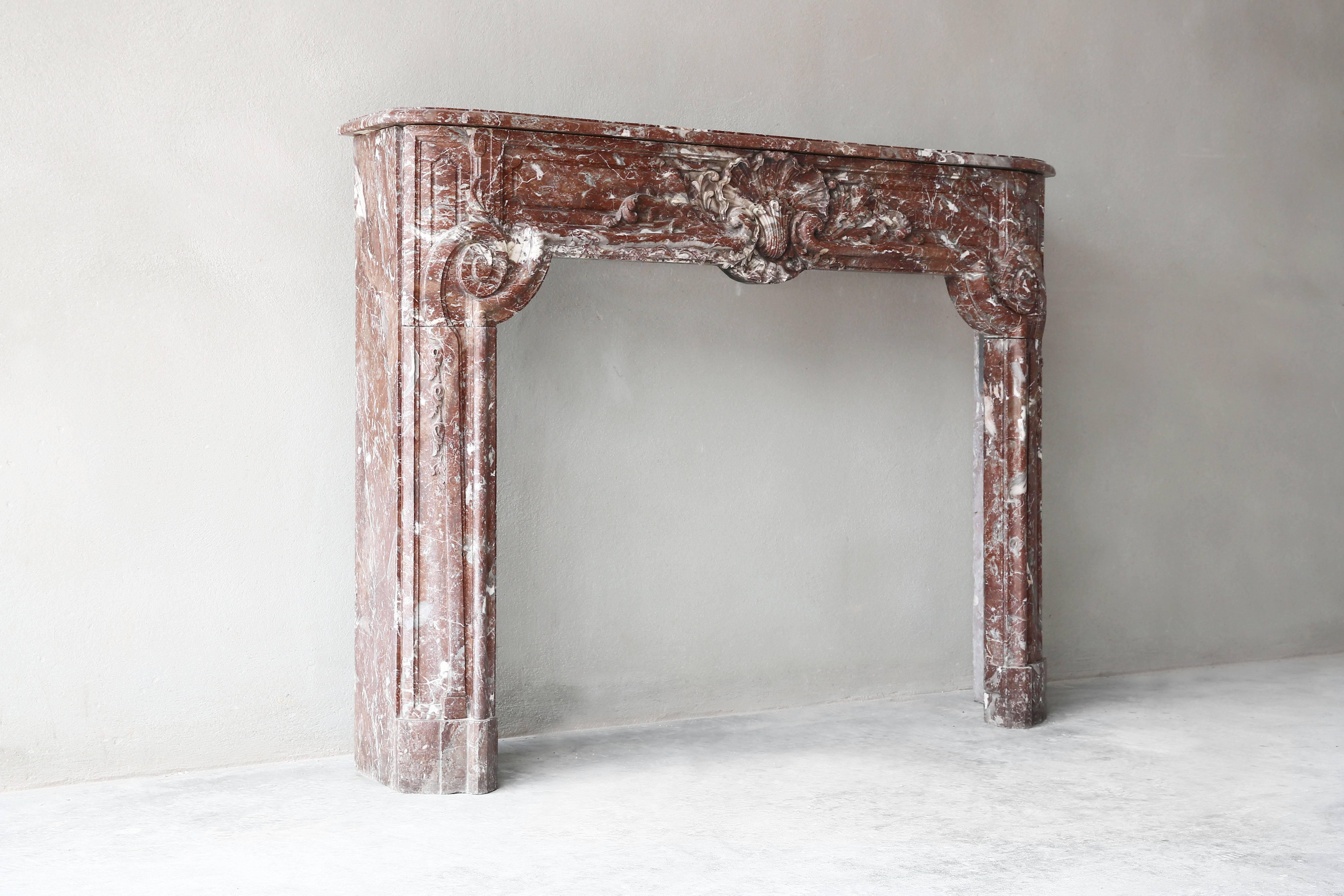 Antique marble fireplace surround carved in Belgium Rouge Royal marble. The colors of the Royal Marble are beautiful red. The fireplace mantel has been beautifully carved with a lot of details.
Period: 18th century
Style: Regency.
Marble: Rouge