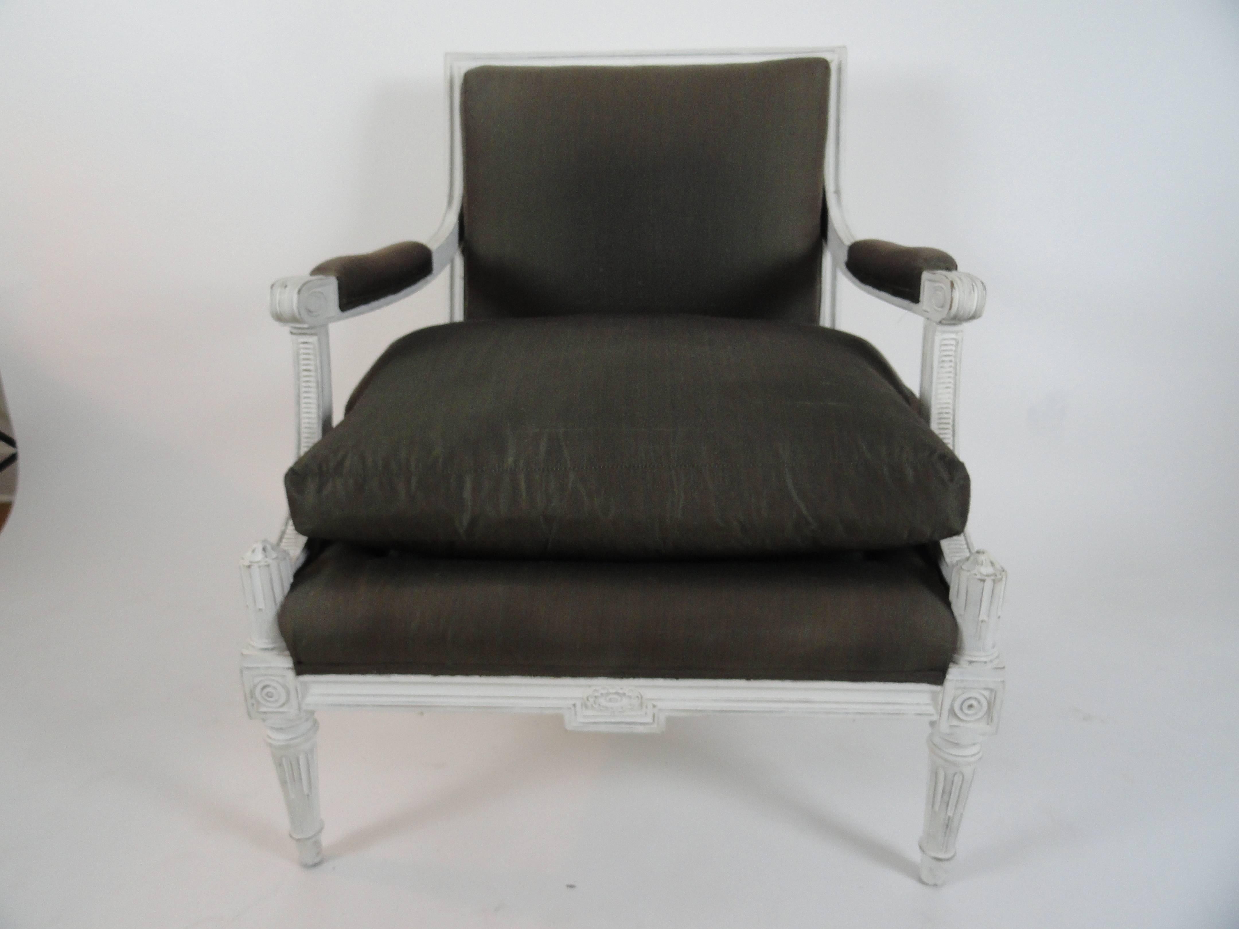 Maison Jansen Louis XVI style armchair or fauteuil. Wood painted white, newer finish, and distressed. Upholstered in Henry Calvin Athena Taffeta (50% silk, 50% cotton). Comfortable.