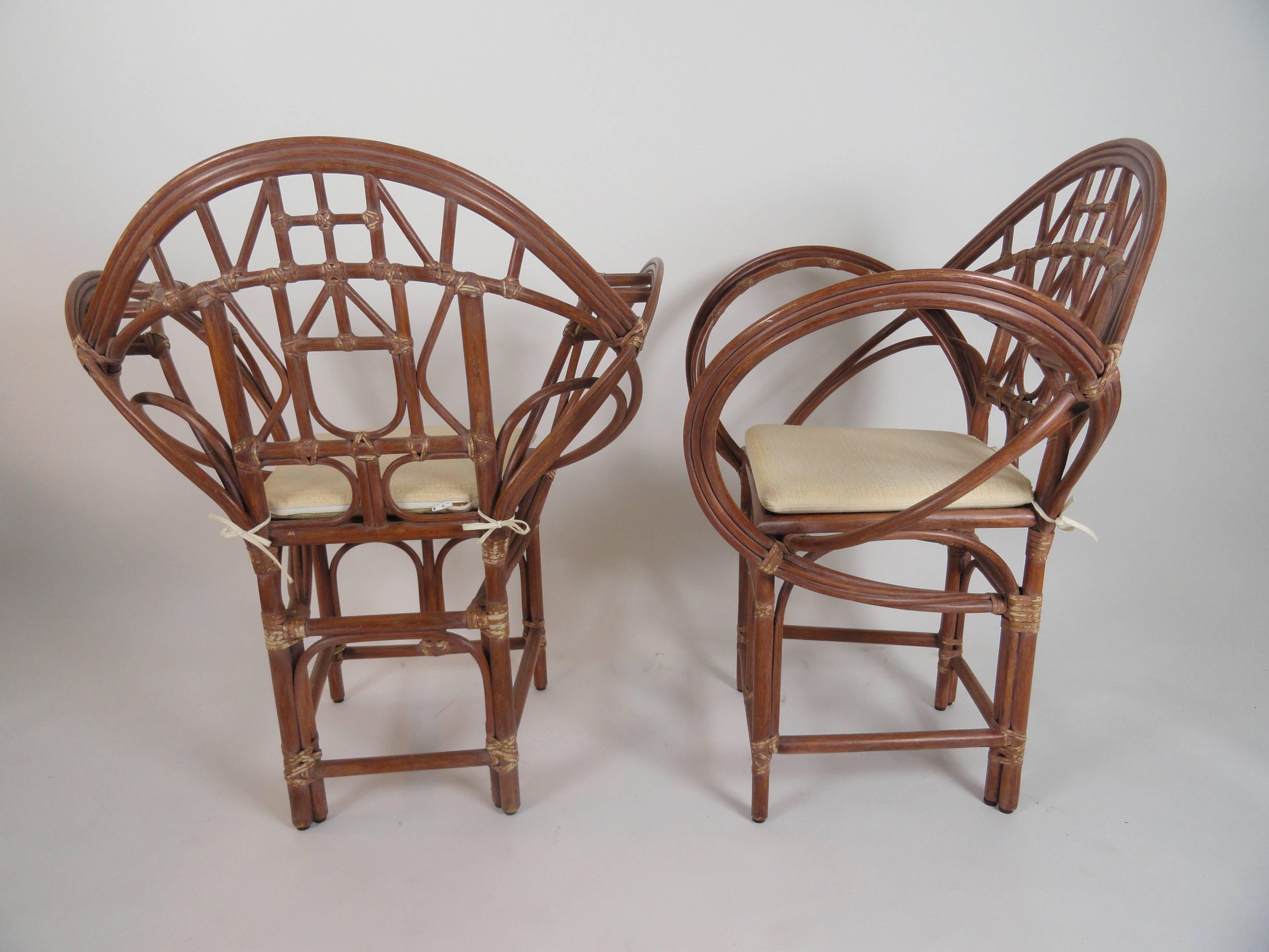 Pair of McGuire Butterfly chairs (M-31).
Designed by Edward Tuttle, McGuire's famous Butterfly chair is a study in fluidity. This graceful design features sweeping arms of delicate rattan. The arching back displays a symmetric series of both curved