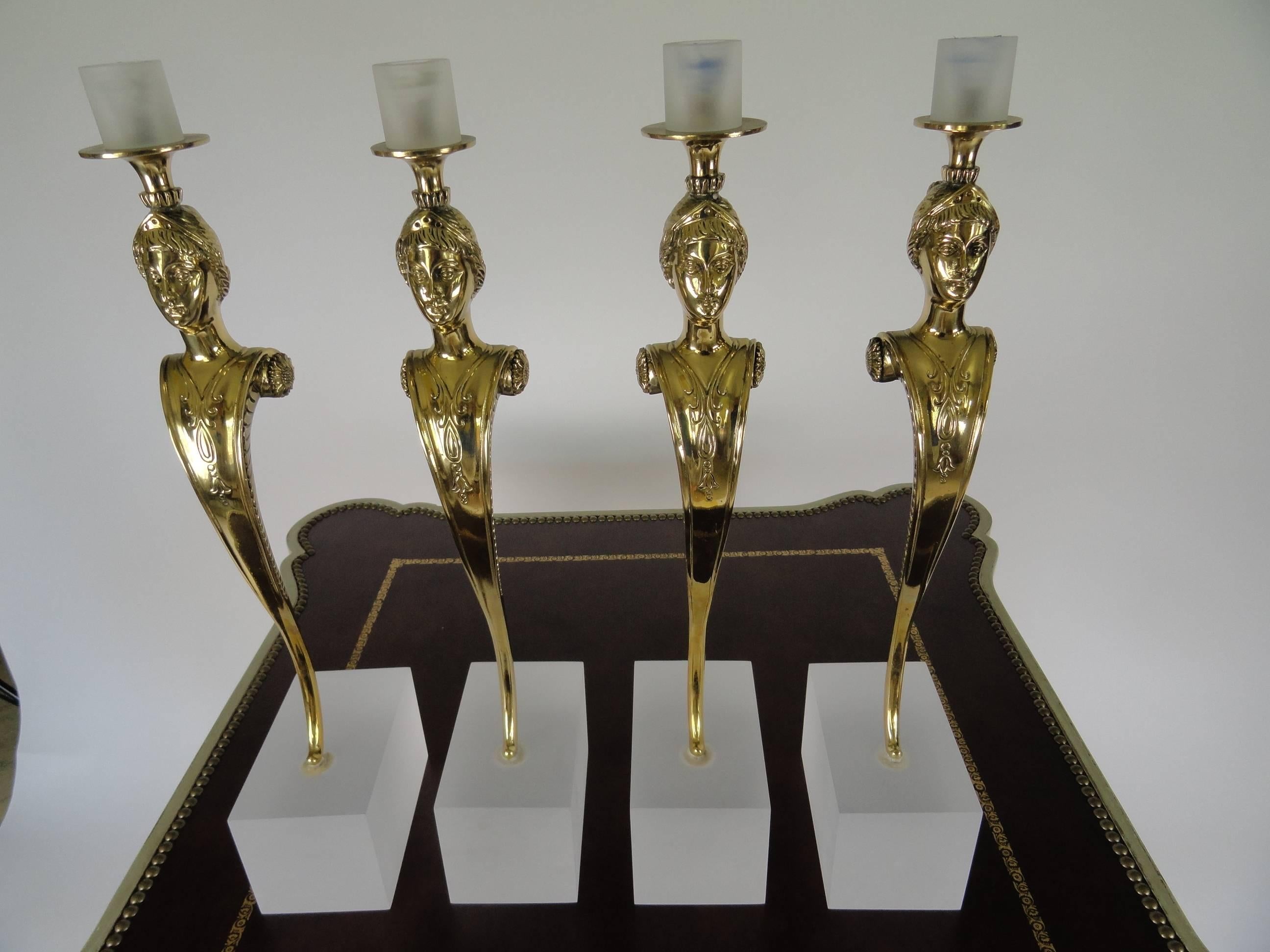 Set of four female figured Italian bronze candle holders featuring beautiful details. Carved breast-plate detail mounted on sand-blasted perspex bases. Candleholders are designed to hold up to 36" tapers. They are stunning in their presence,