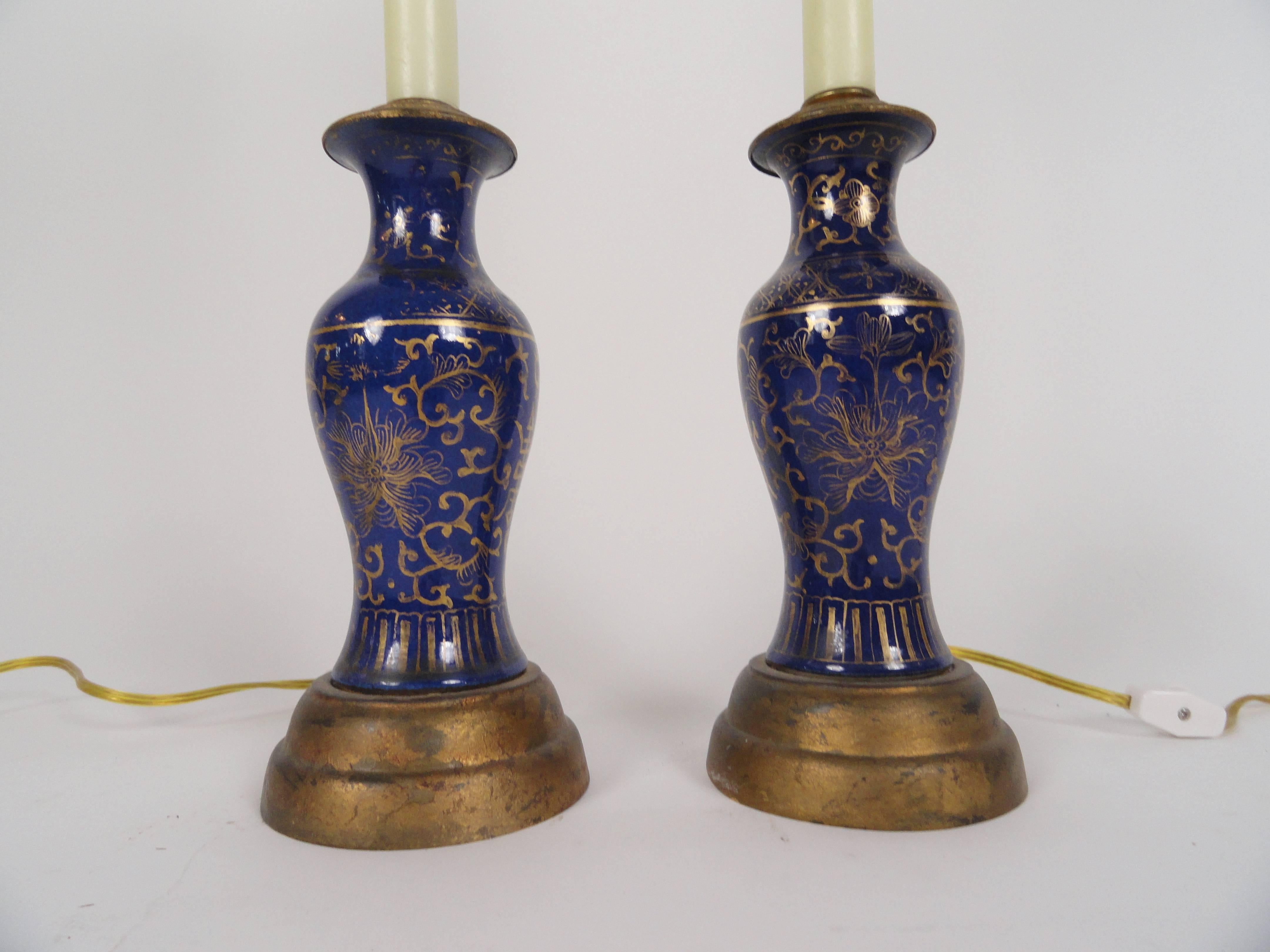 Pair of oriental powder blue candlestick lamps on gold bases. Fortuny half shades. Newly rewired with inline switches.
Measure: Height is 22