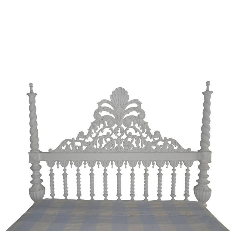 King-size plantation style four-poster wood bed. Head board features twist columns with an elegant carved cartouche. Fours posters are carved wood in a twist pattern. Beautiful detail on base of bed. Custom white painted finish. Bed frame only. Does