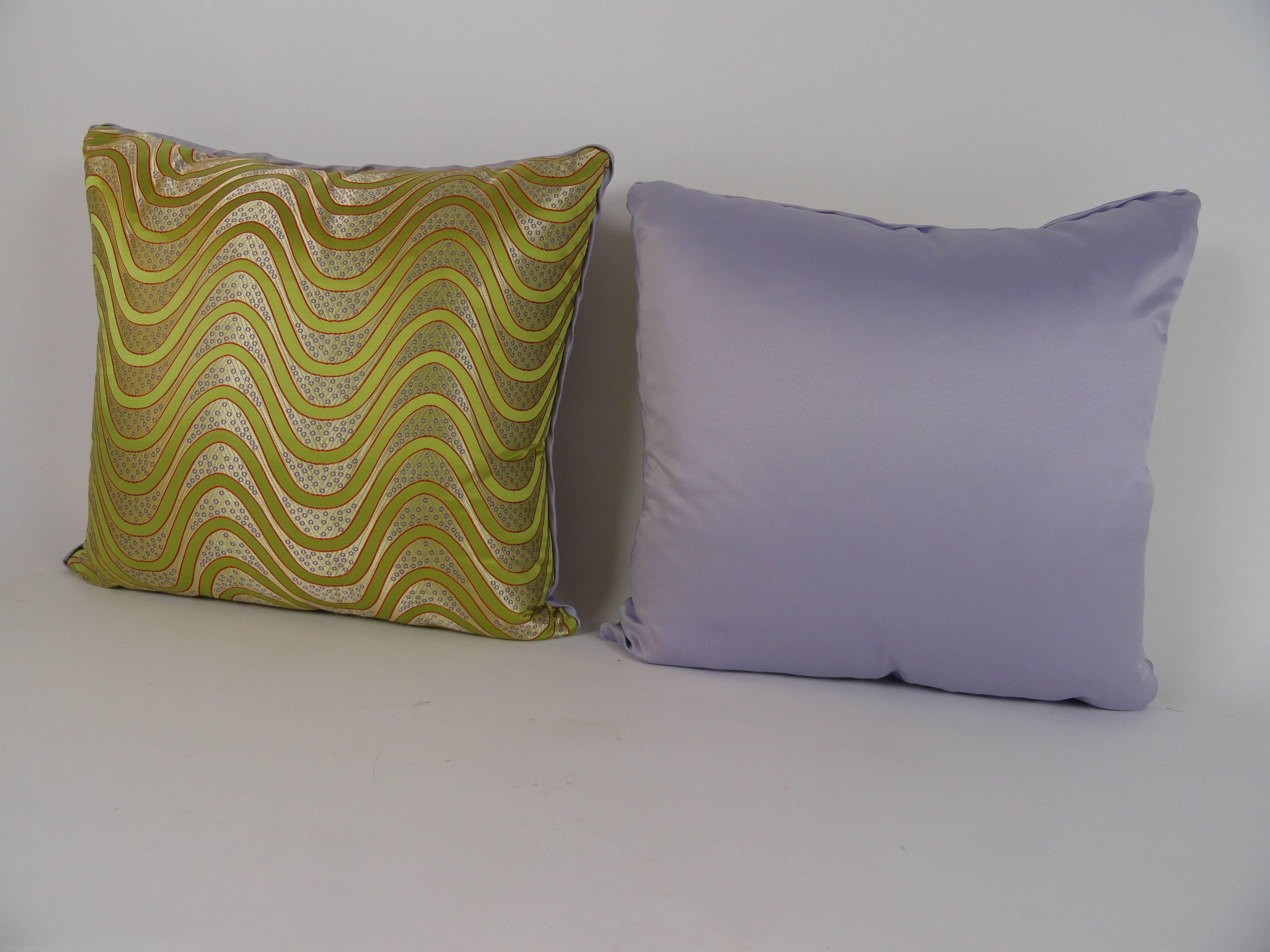 Pair of custom Chinese silk pillows in chartreuse pattern. Back in lilac silk. Measure: 24