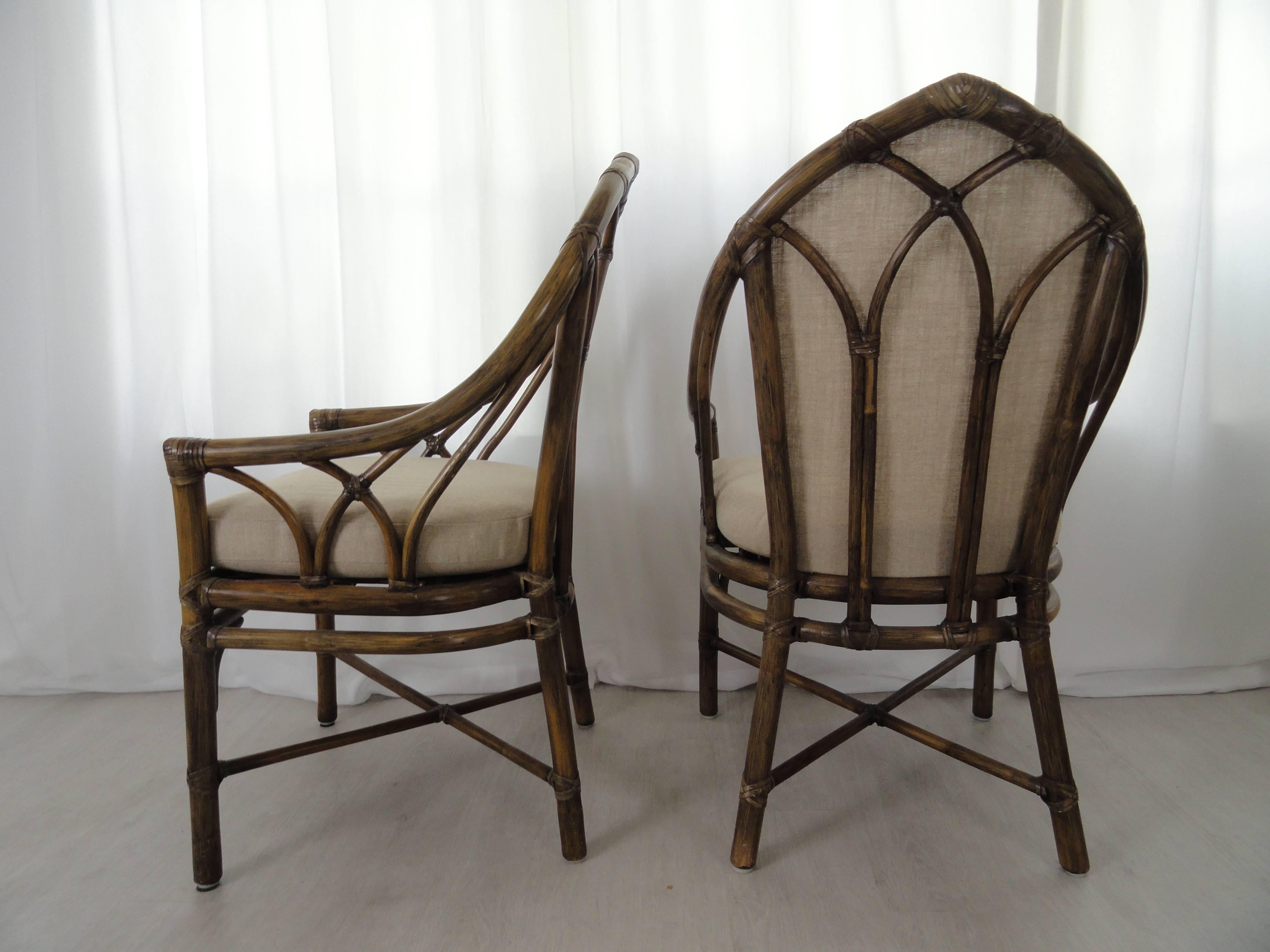 Set of six dining armchairs from McGuire Furniture. Two have upholstered backs and four have open backs. Cushions and backs upholstered in Scalamandré silk. All in excellent condition. McGuire tag on bottom.