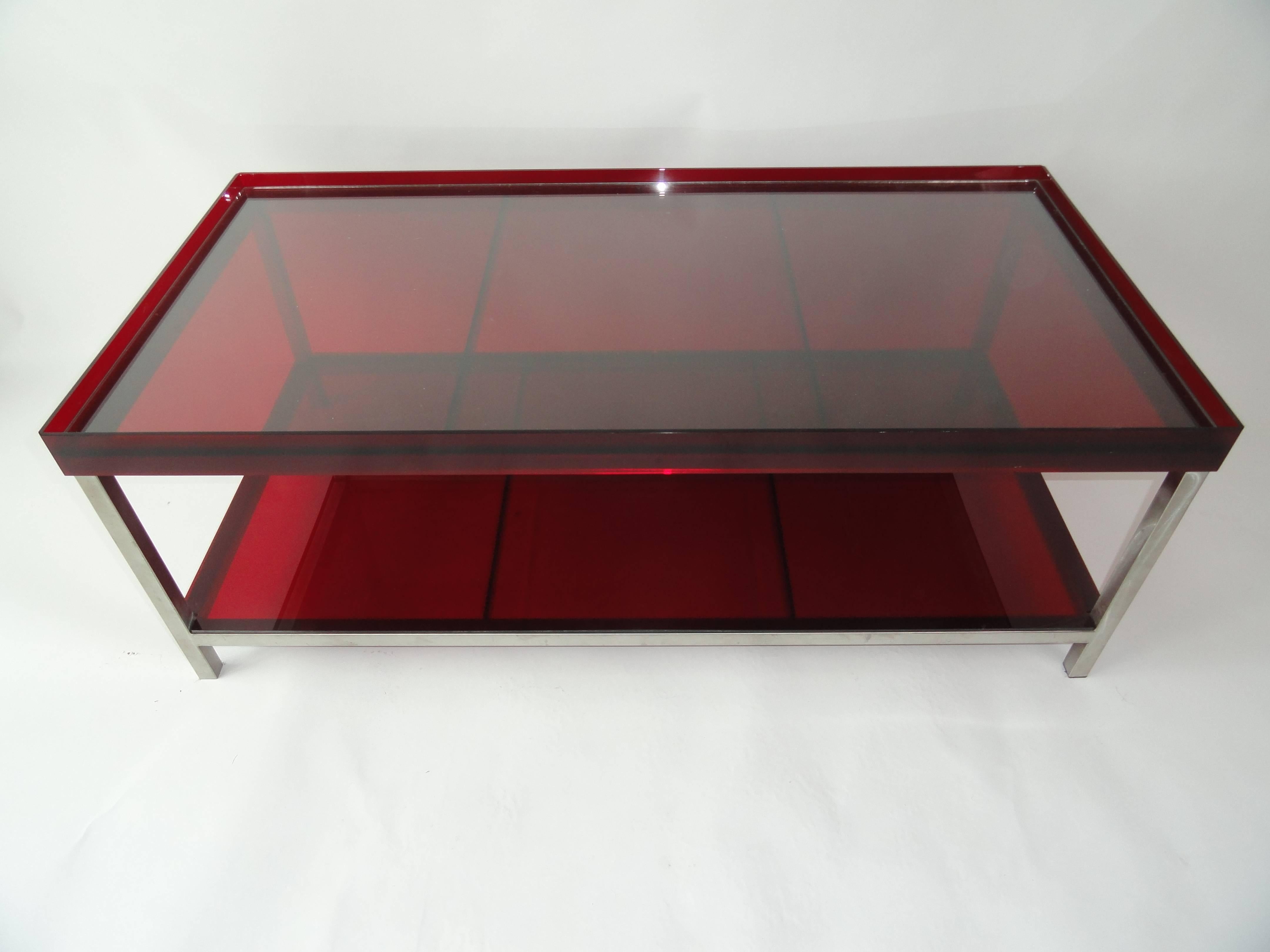 Modern brushed steel coffee table with red acrylic tray top and red acrylic lower shelf. Top has a glass insert to protect the acrylic top from scratching and help hold more weight.