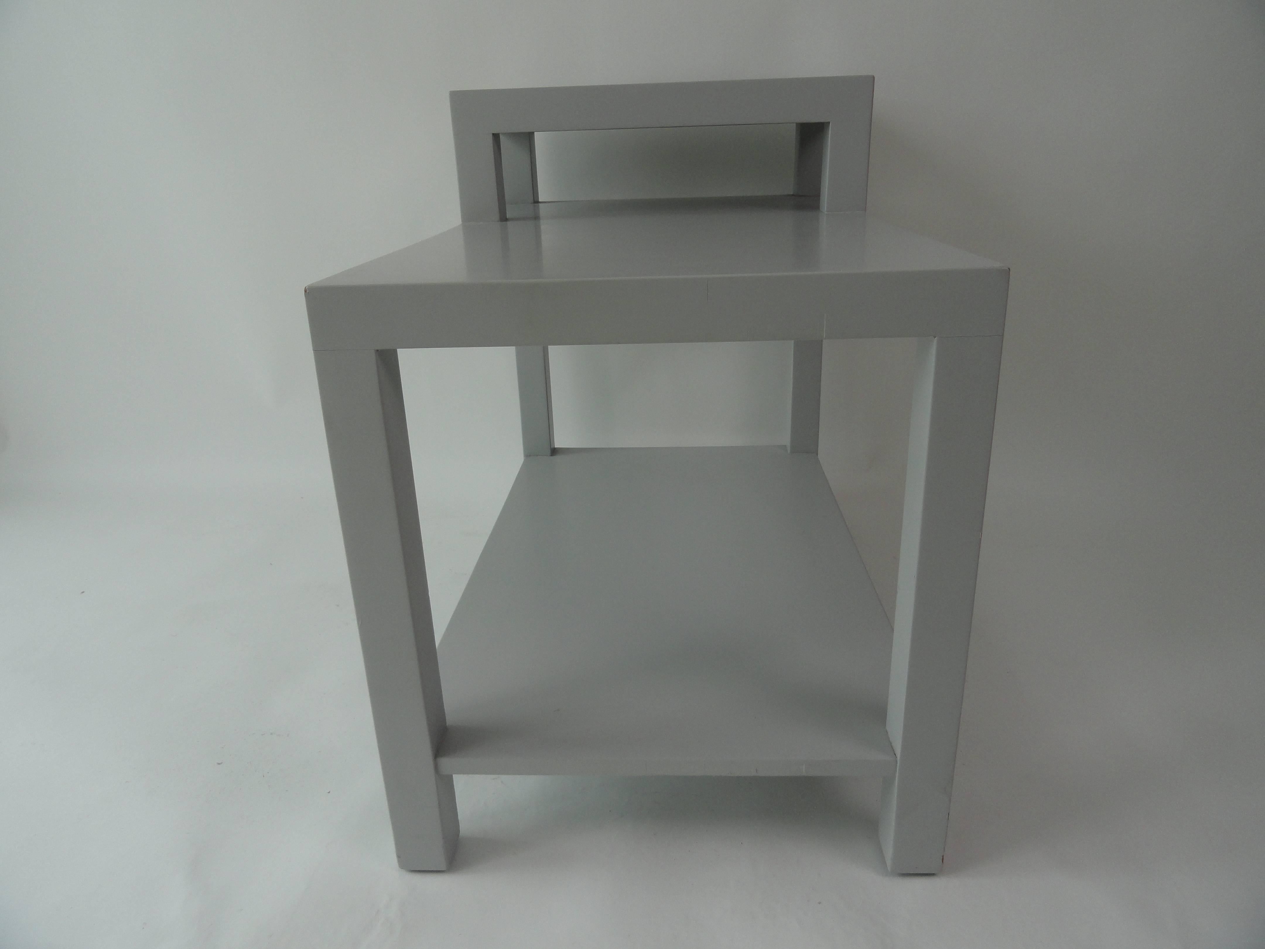 T.H. Robsjohn-Gibbings step table finished in light grey for John Stuart Furniture. Labelled.
