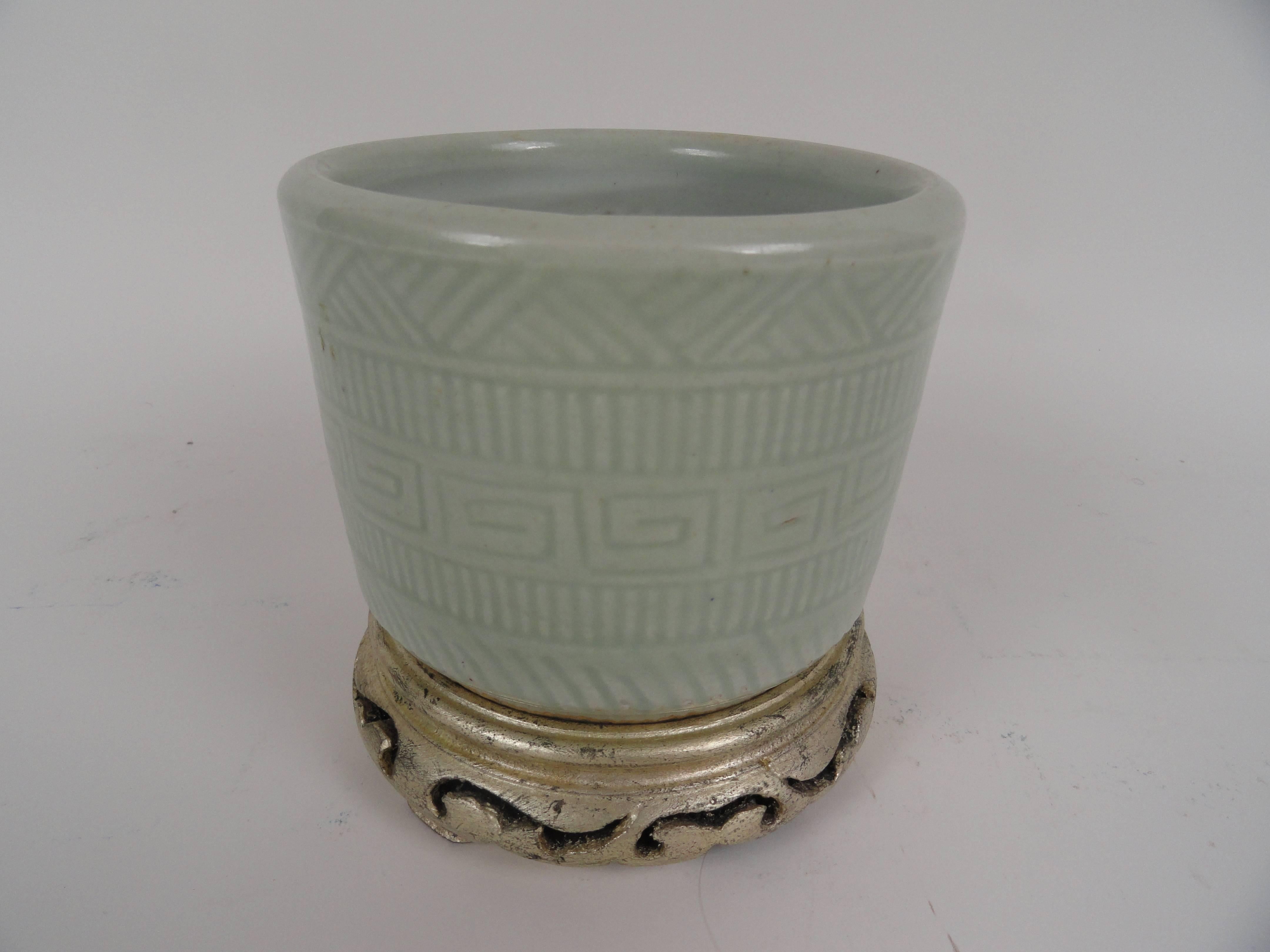 19th century Chinese porcelain brush pot in soft celadon. Rests on custom silver leaf teak base.