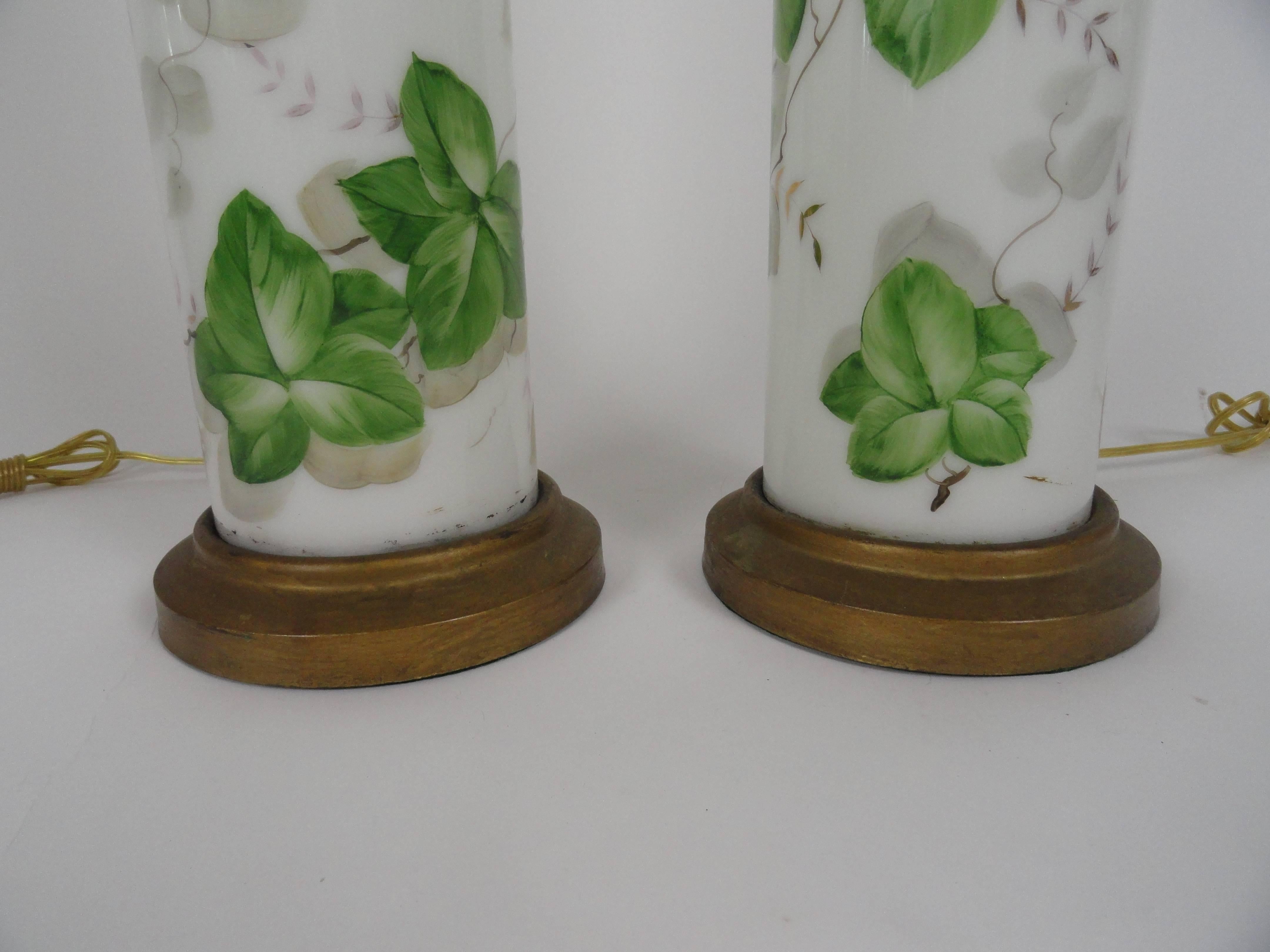 Pair of large-scale American made white glass lamps with hand-painted foliage in shades of green. Metal bases. Rewired with inline switches.