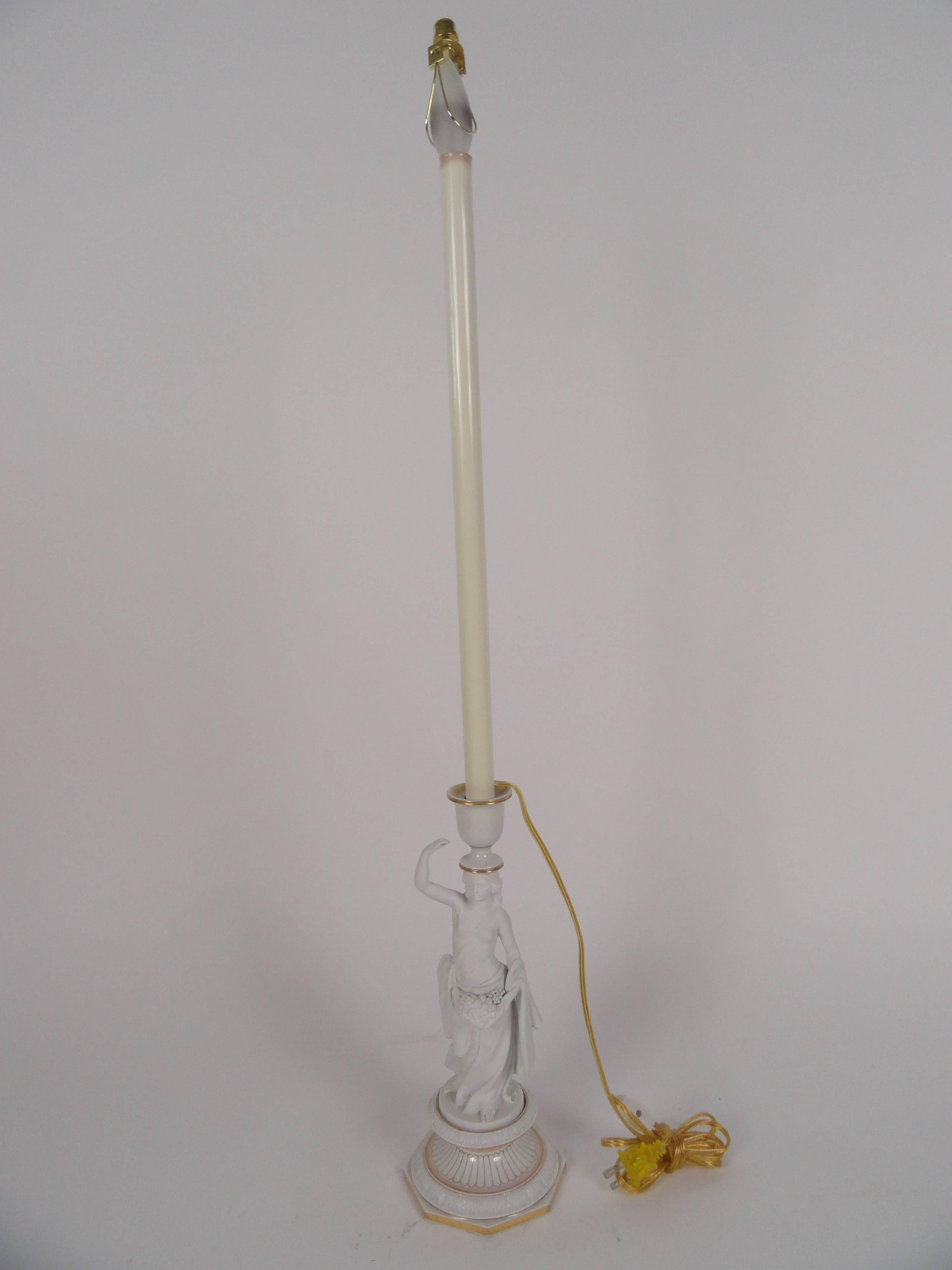 White bisque female figure lamp. Gold leaf detail. Markings on bottom. Newly wired with inline switch. Measures: Height to top of figure is 13
