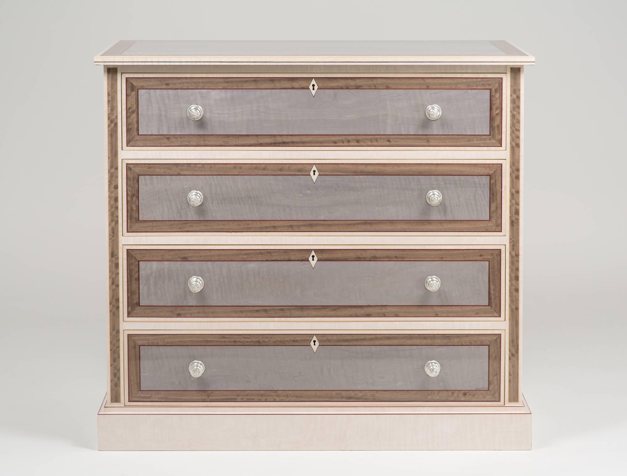 This magnificent chest of drawers is handcrafted by our highly skilled English craftsmen deep in the heart of the Sussex countryside in England. 
The sides and top are of Italian Sycamore within a Silver Eucalyptus framed banding and lined with