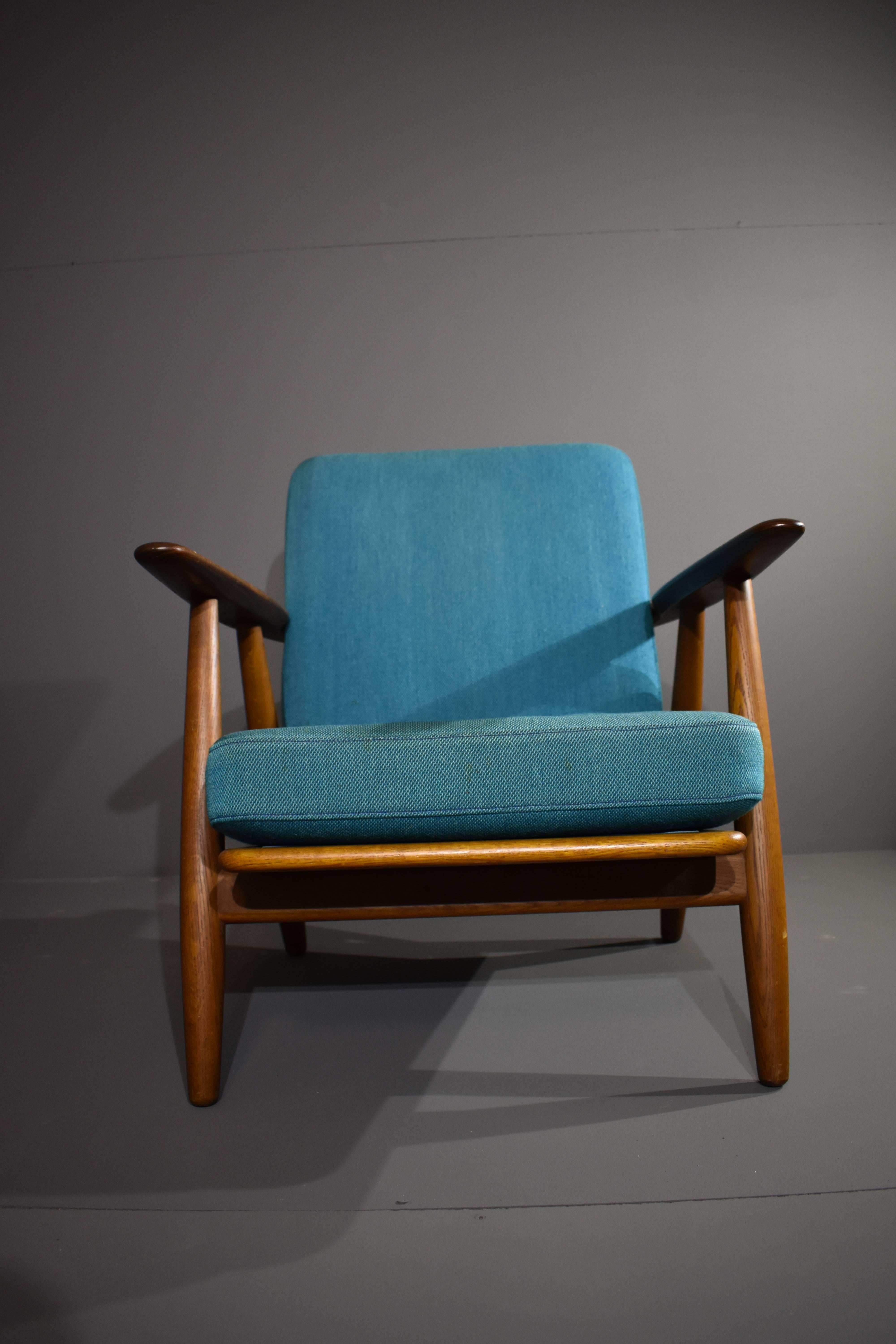 Hans J. Wegner's GE-240 in solid teak, with blue fabric upholstery.