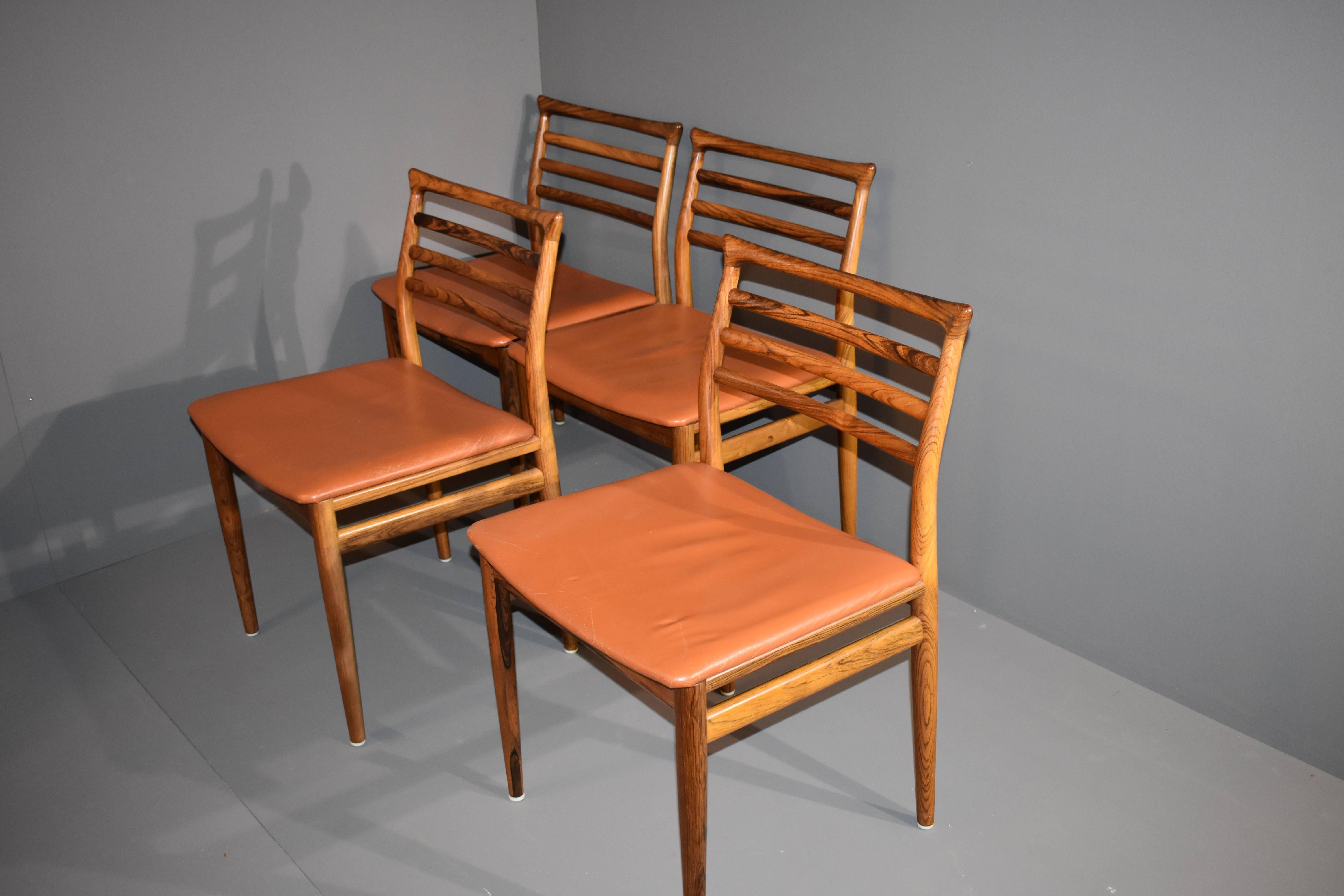 Set of four chairs in rosewood with stunning details. 
Leather upholstery with minimun signs of wear.
 