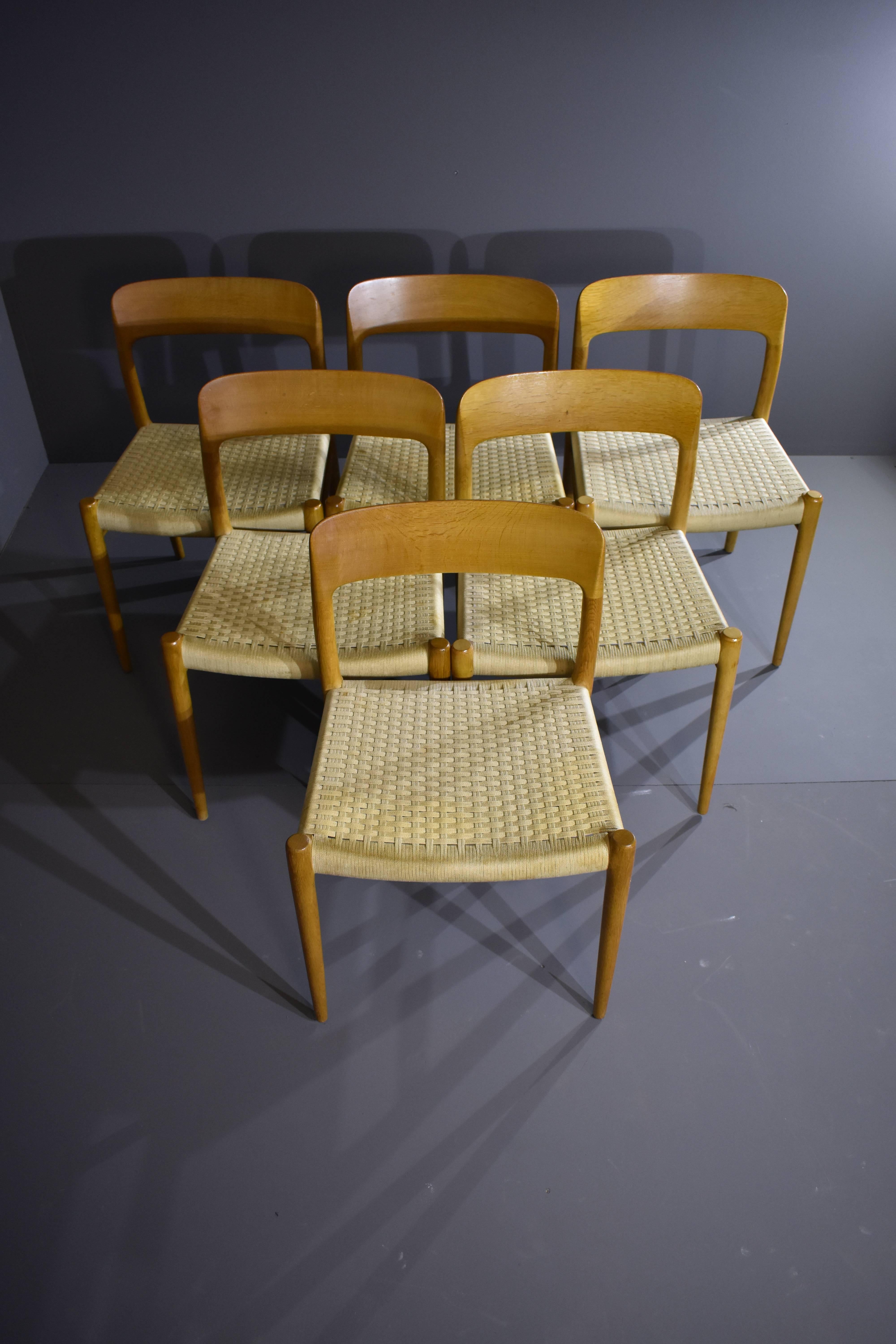 Niels Otto Møller set of six dining chairs in oak, for J.L. Møllers Møbelfabrik.
Solid oak with original paper cord seats.