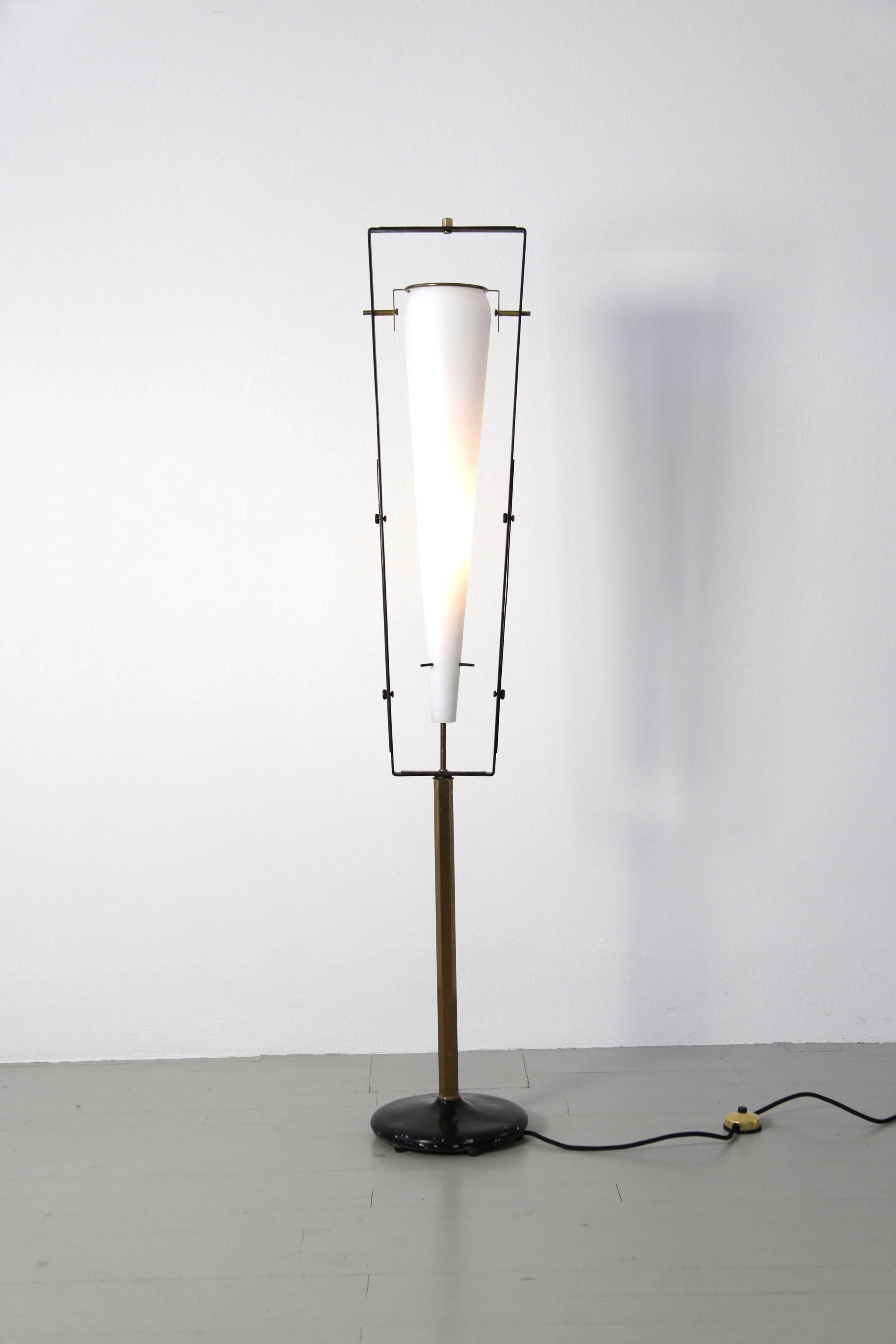 A captivating piece from the 1950s, this floor lamp is a creation of Gilardi & Barzaghi, renowned designers from Italy. Its design features a large satinated glass shade delicately nestled within a framework crafted from brass, exuding a harmonious