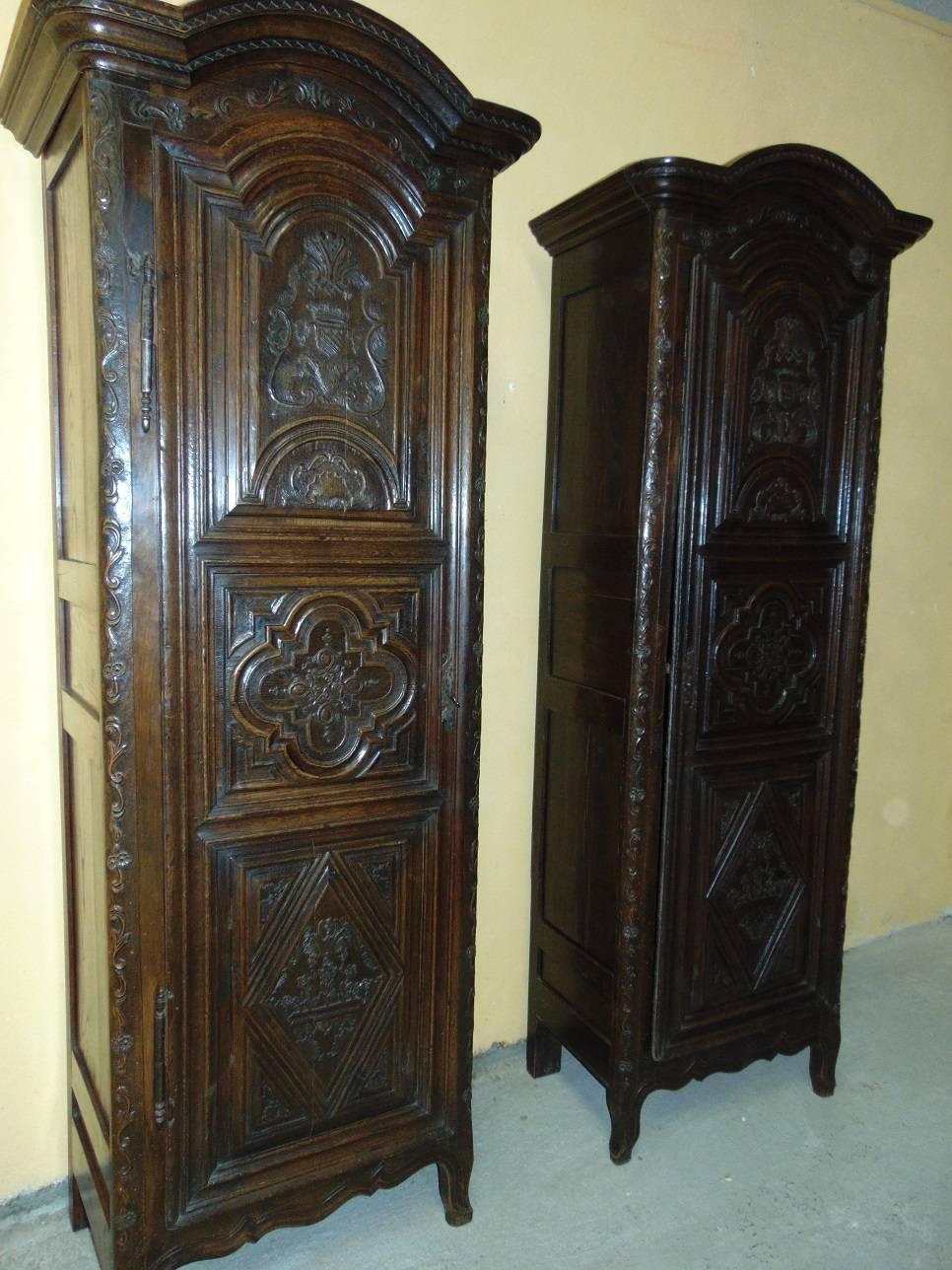 FREE WORLDWIDE SHIPPING OFFERED ON THIS ITEM 
A very rare and important pair of French marriage Armoires (Bonnetieres) from Normandy made in the mid-1700s in solid oak and richly carved with the personal crests of the two families joined by this